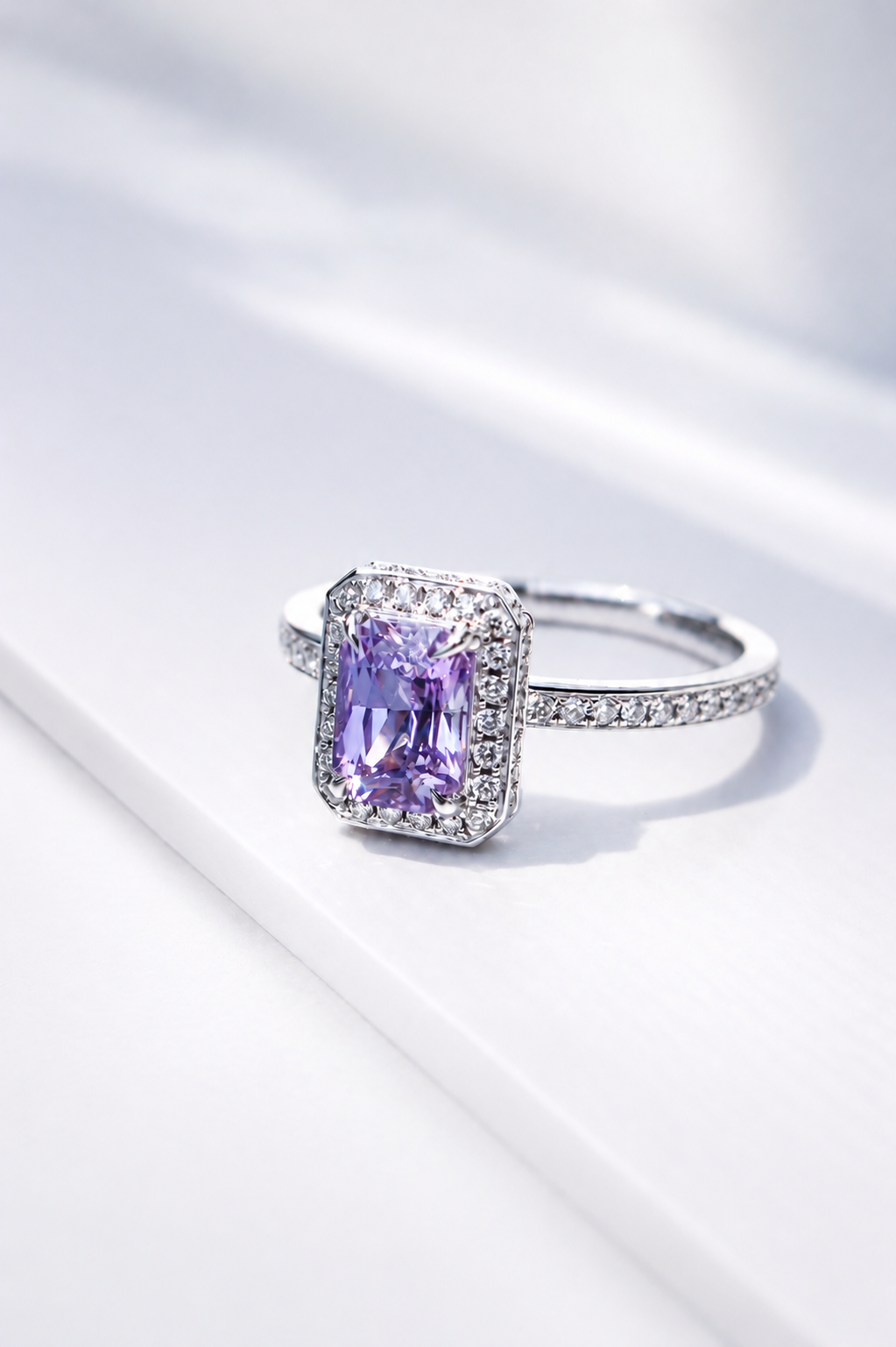 Natural unheated lilac sapphire with diamonds in halo design by Sophie Cudworth