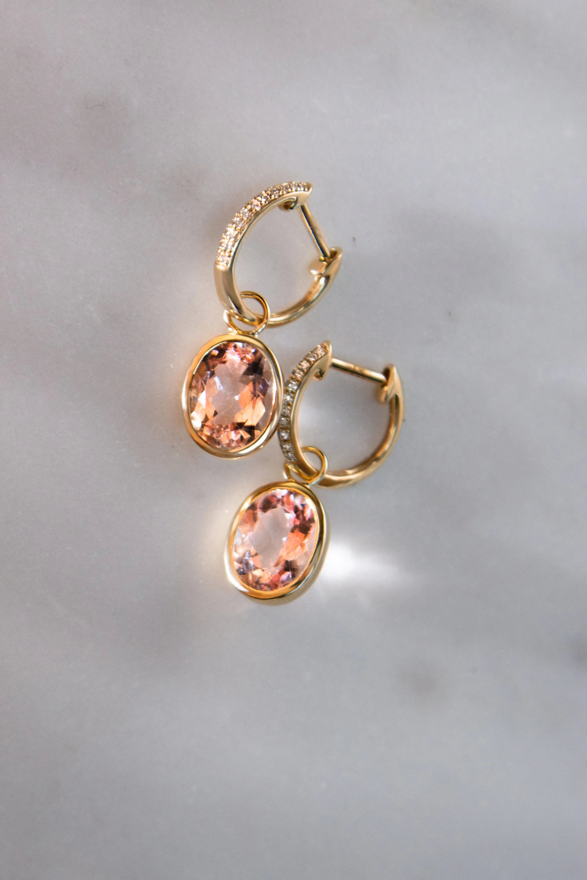 14K rose gold earrings by Sophie Cudworth with oval cut morganites and diamond set huggies