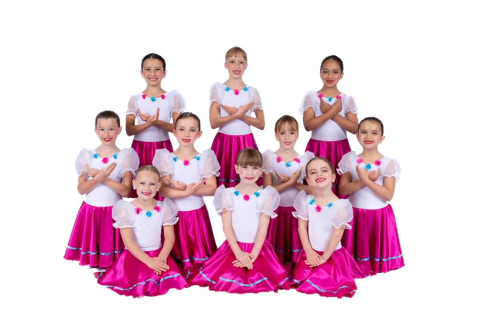 Young ballet dancers in pink and white costumes