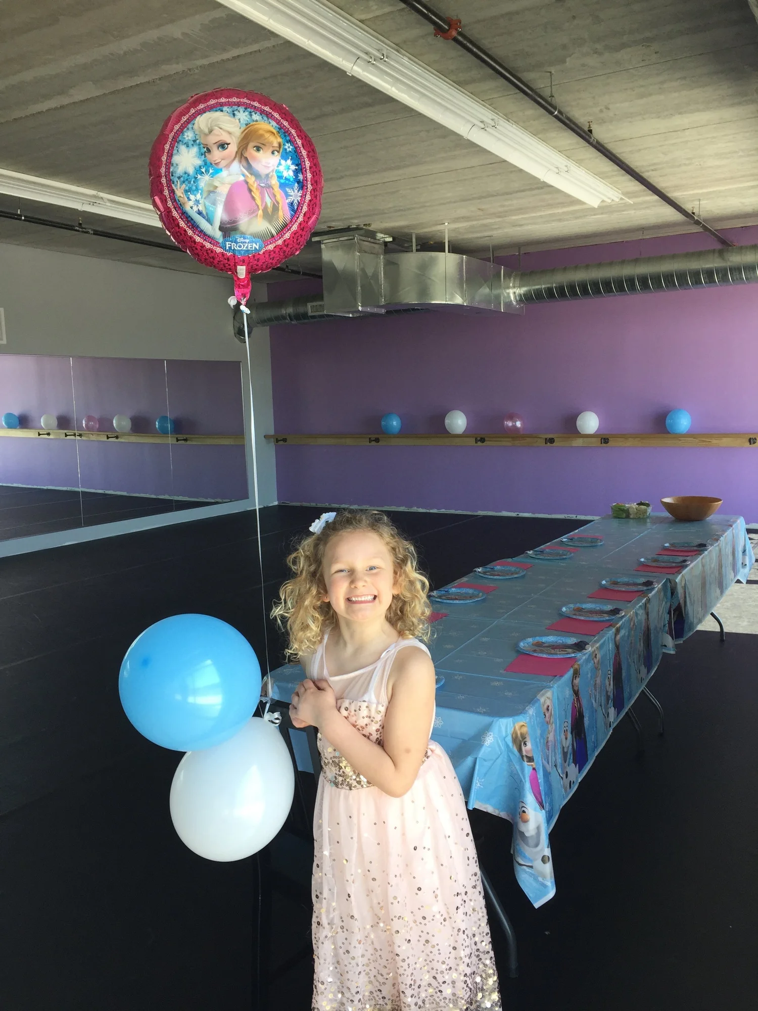 Child smiling at a decorated birthday party in Guelph