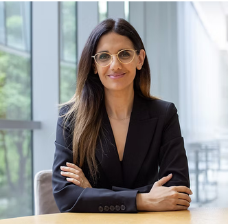 woman with long brown hair wearing a black blazer