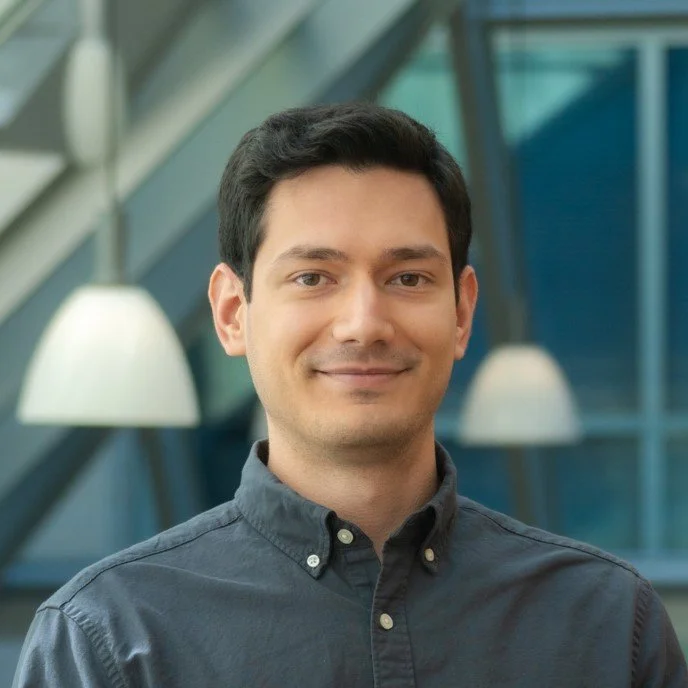 Panos in long sleeved shirt, smiling