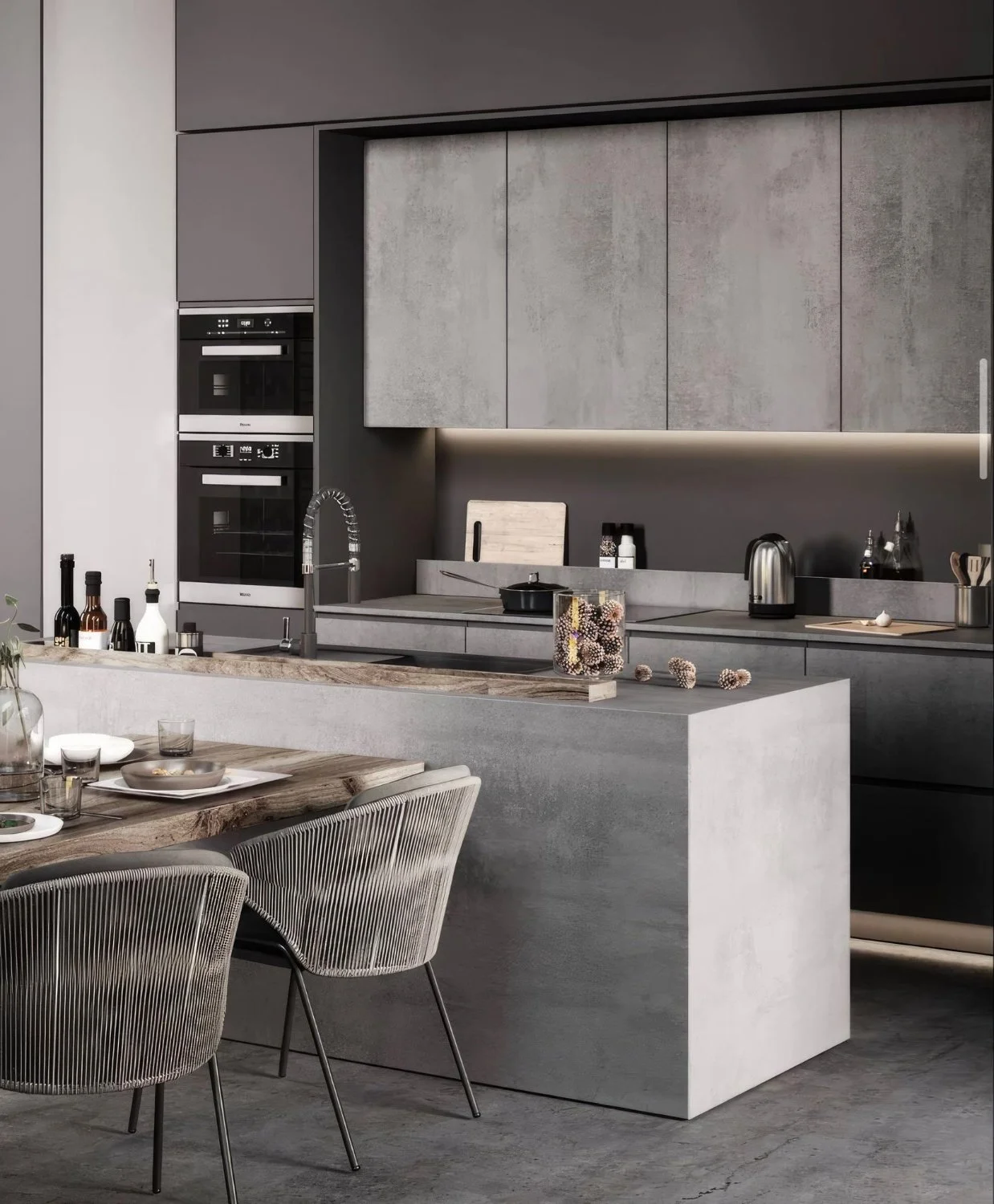 Modern kitchen with gray cabinets, concrete countertops, and a wooden dining table with chairs.
