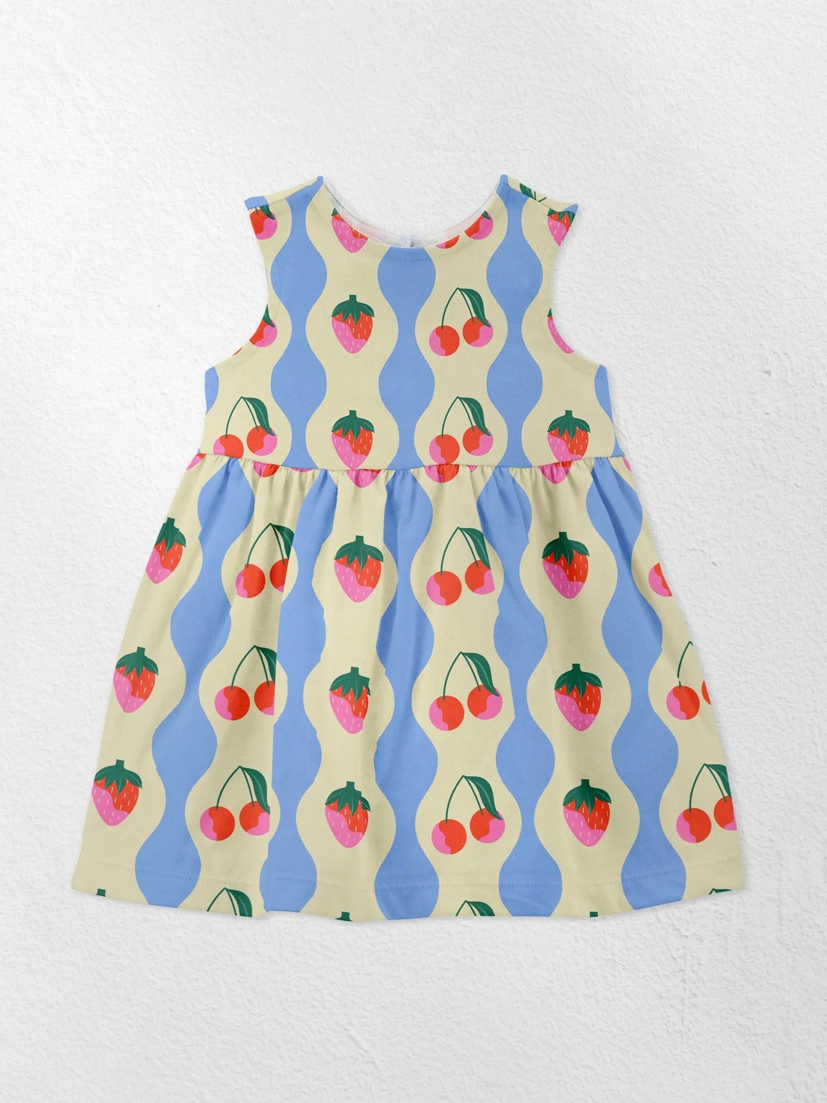 A sleeveless children's dress with a cherry and strawberry pattern on a cream and blue striped background.