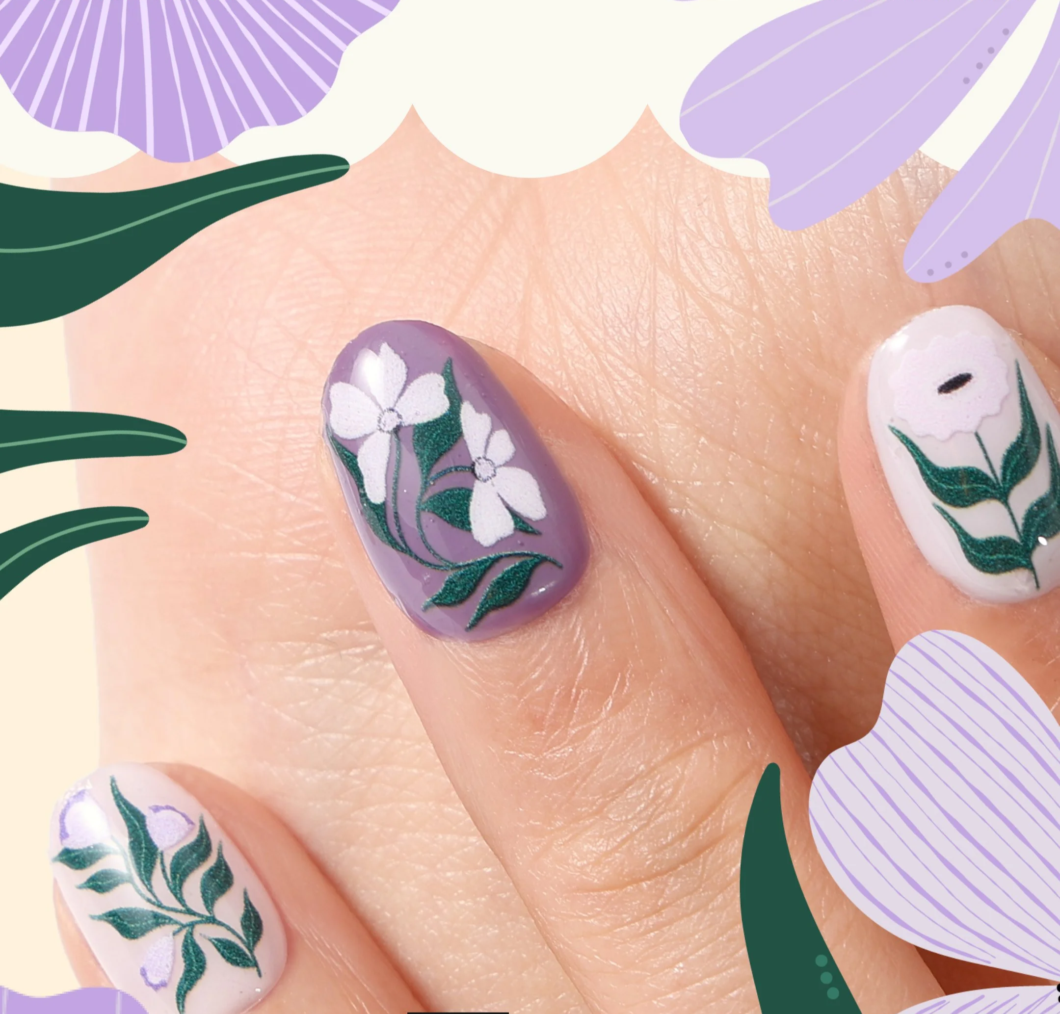 Close-up of a hand showing decorated fingernails with floral nail art, featuring white, purple, and green designs.