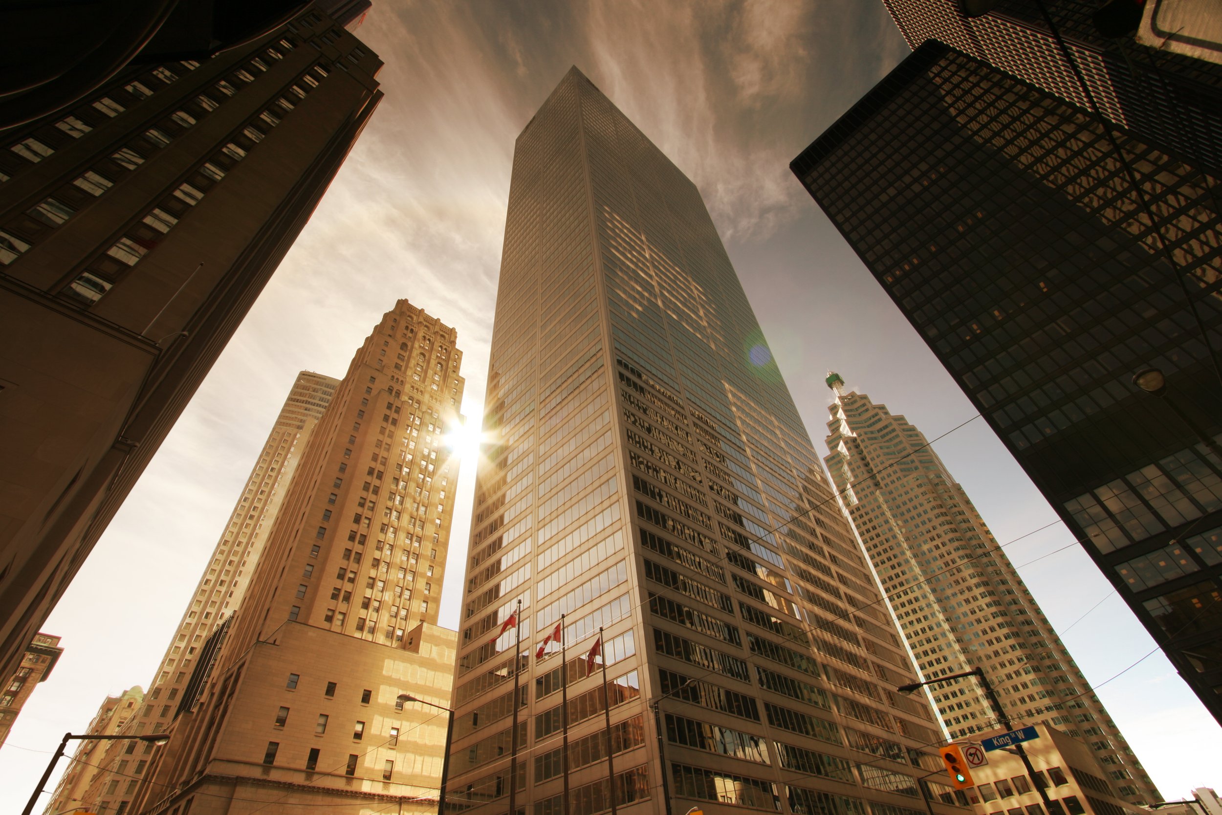 Urban skyscrapers with sunlit glass facades representing real estate investment and growt