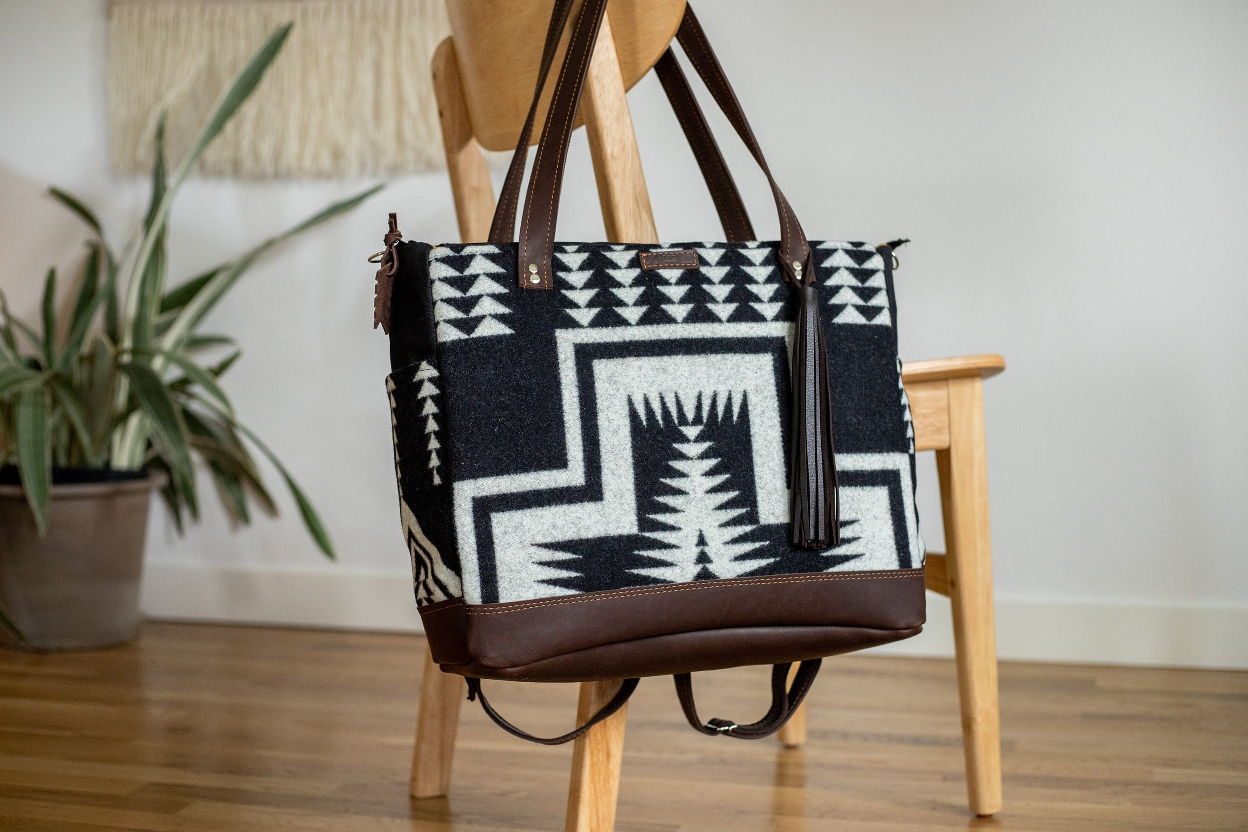 black and white diaper bag with western style on a back of a chair