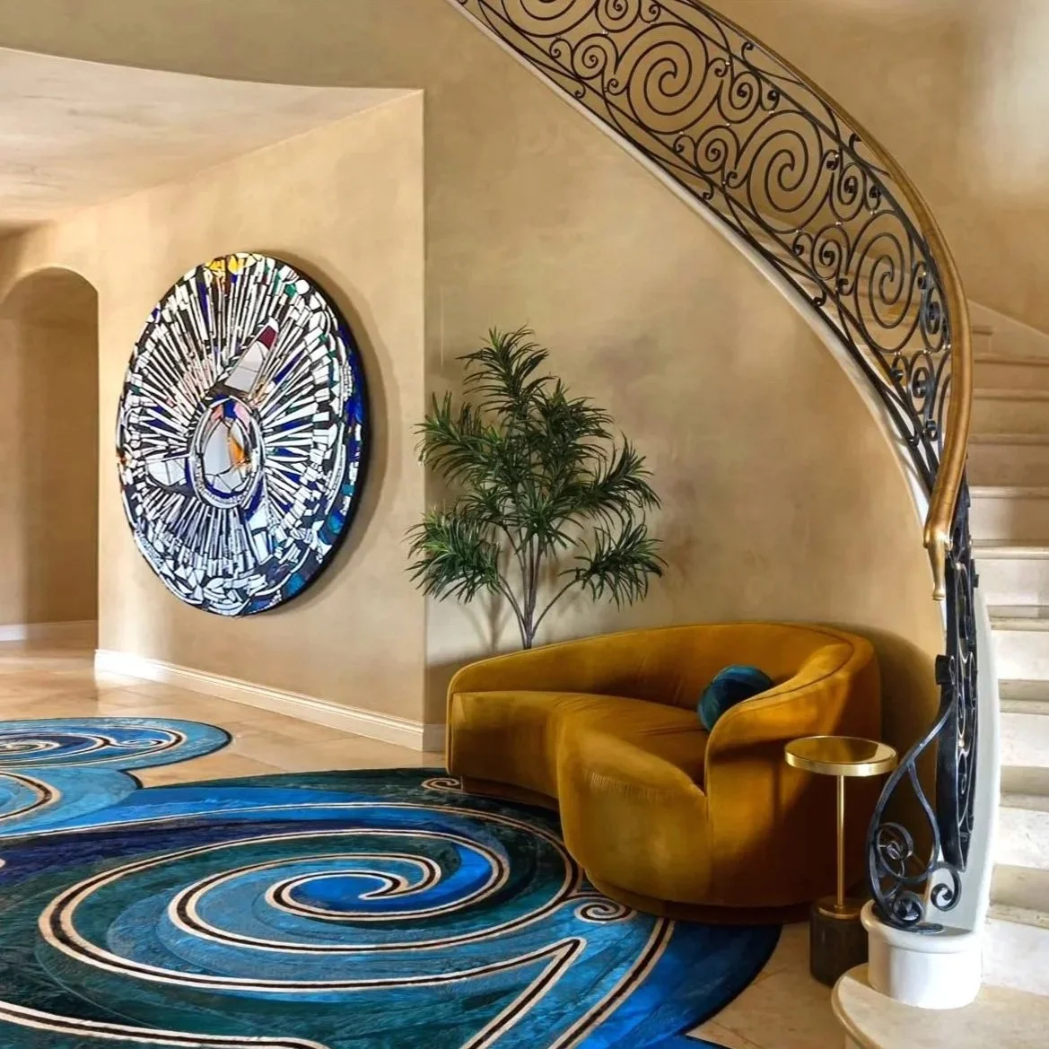 Interior space featuring a large, round mirror abstract art piece on the wall in a luxurious entryway featuring spiral motifs throughout.