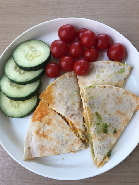 Quesadilla with chicken and avocado, cucumbers and tomatoes