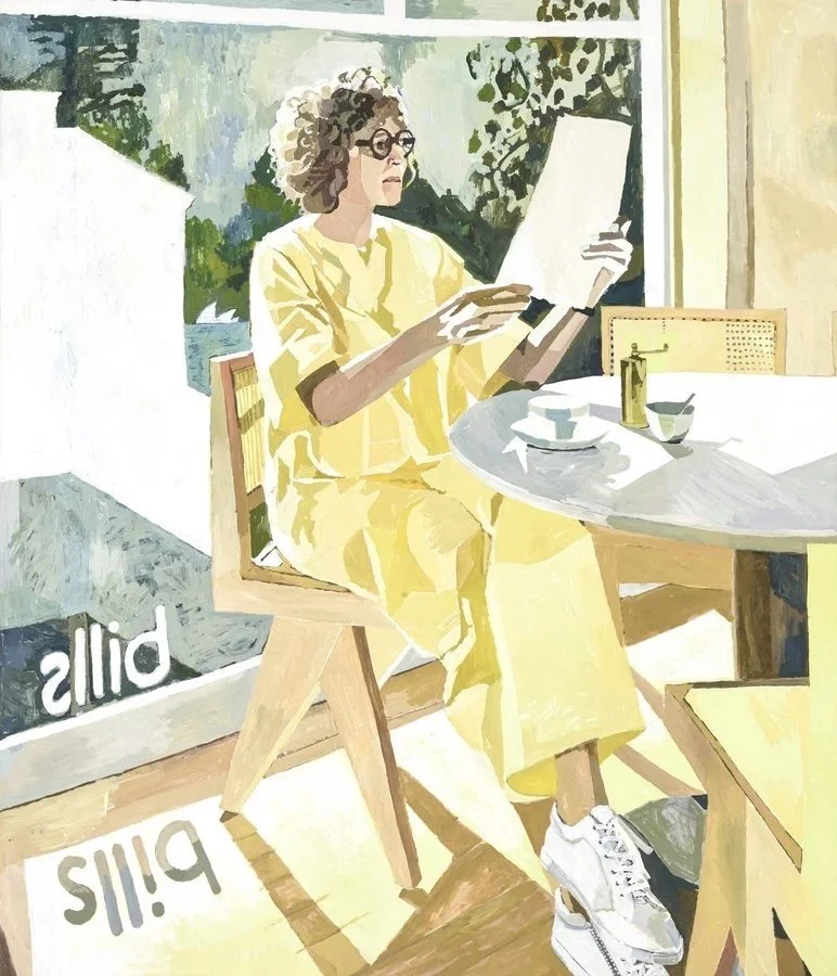 Archibald prize portrait of Jill Dupleix  woman with curly hair and glasses sits at a dining table, reading a book or magazine, dressed in a yellow outfit, in a sunlit room with large windows and greenery outside.