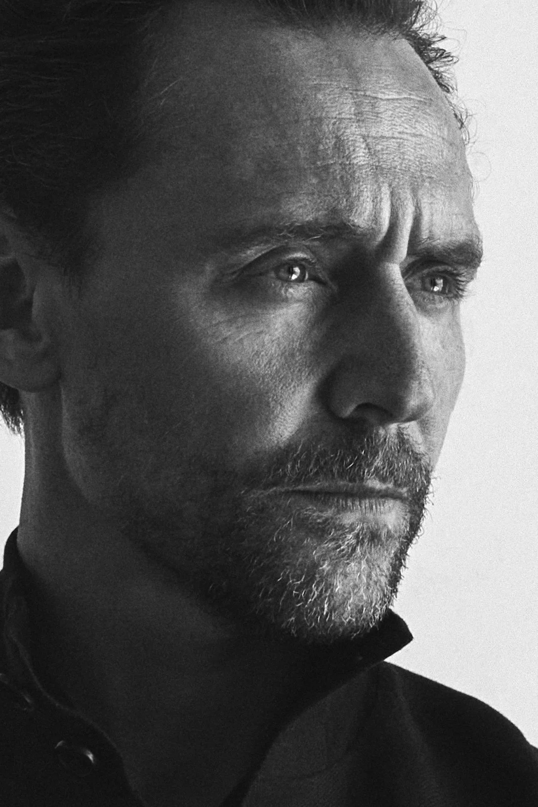 Tight black-and-white portrait of Hugh Dancy