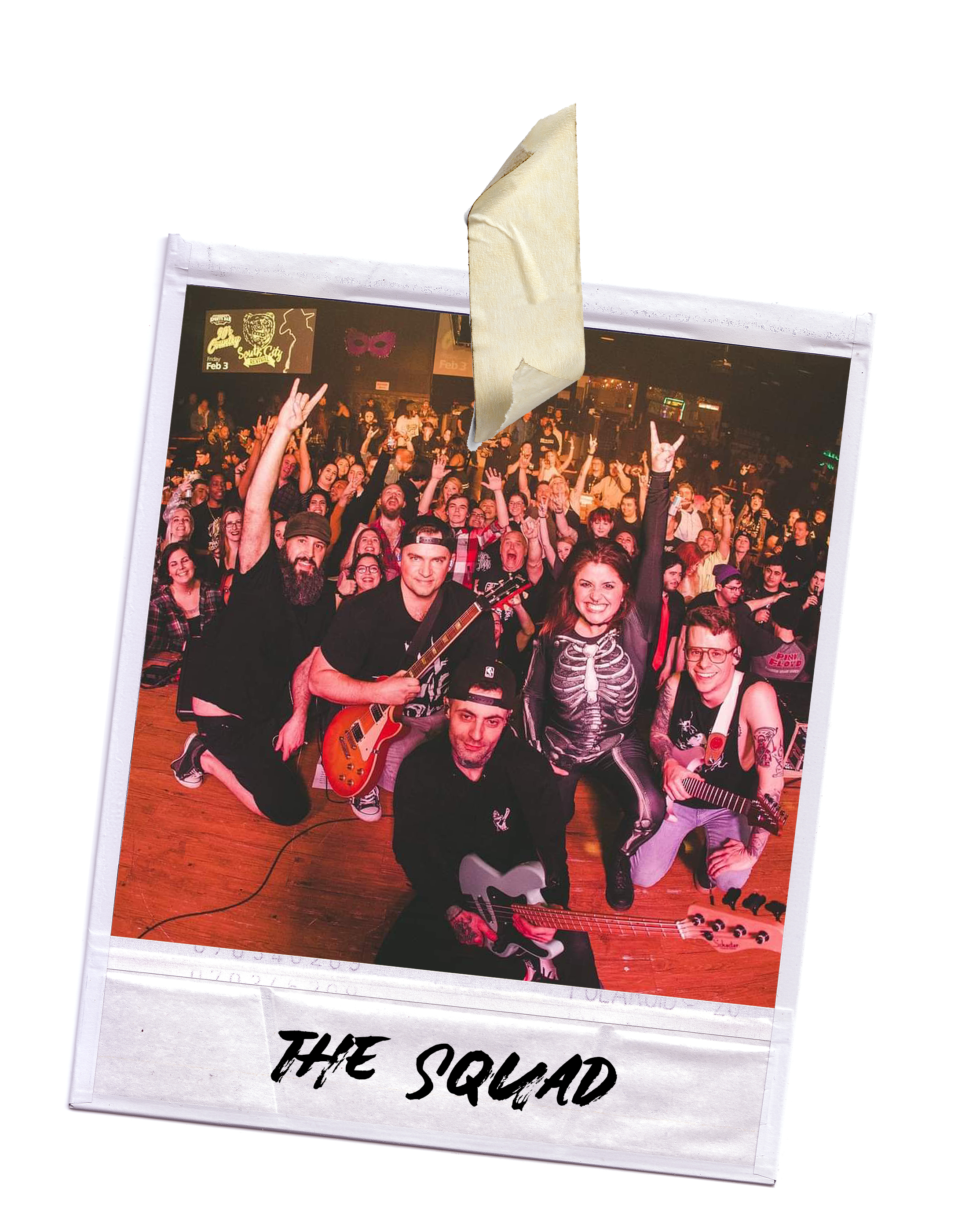 A taped up polaroid photo of the band performing on stage with an energetic crowd in the background, some raising their hands.