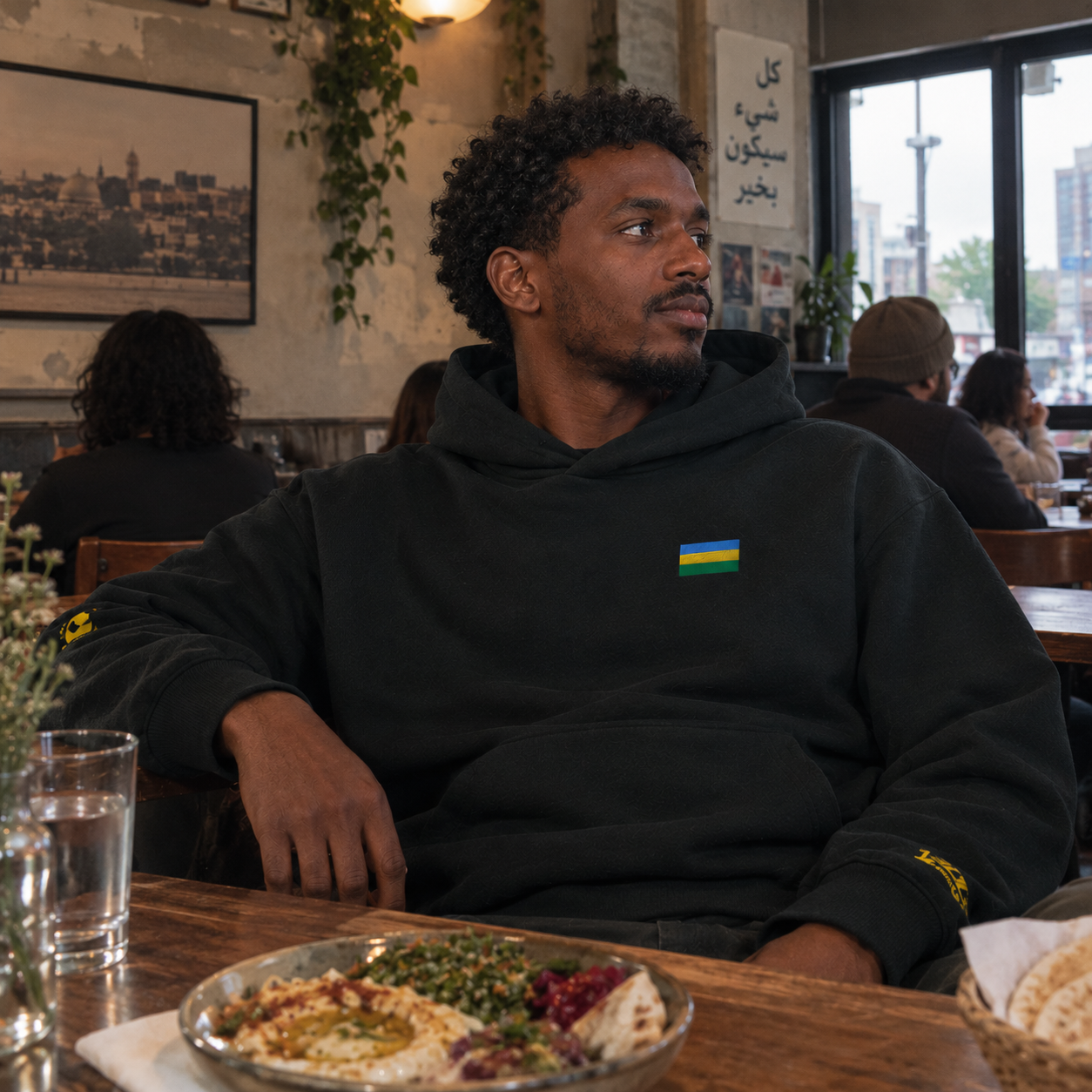 Contemplative Café Portrait with Mediterranean Fare.png