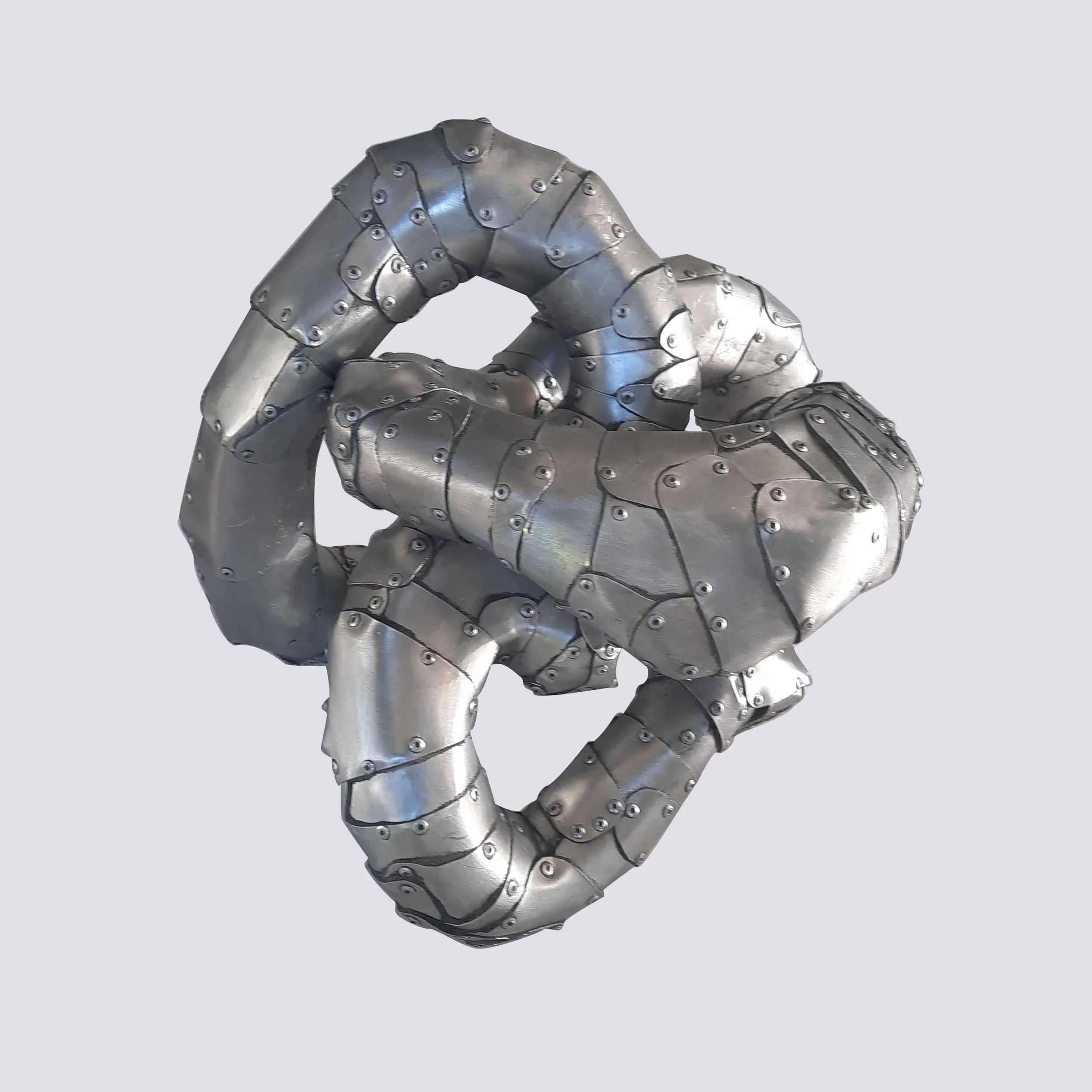 An aspect of a sculpture made of riveted aluminium by Stephen Bond entitled Five Lumps Loop