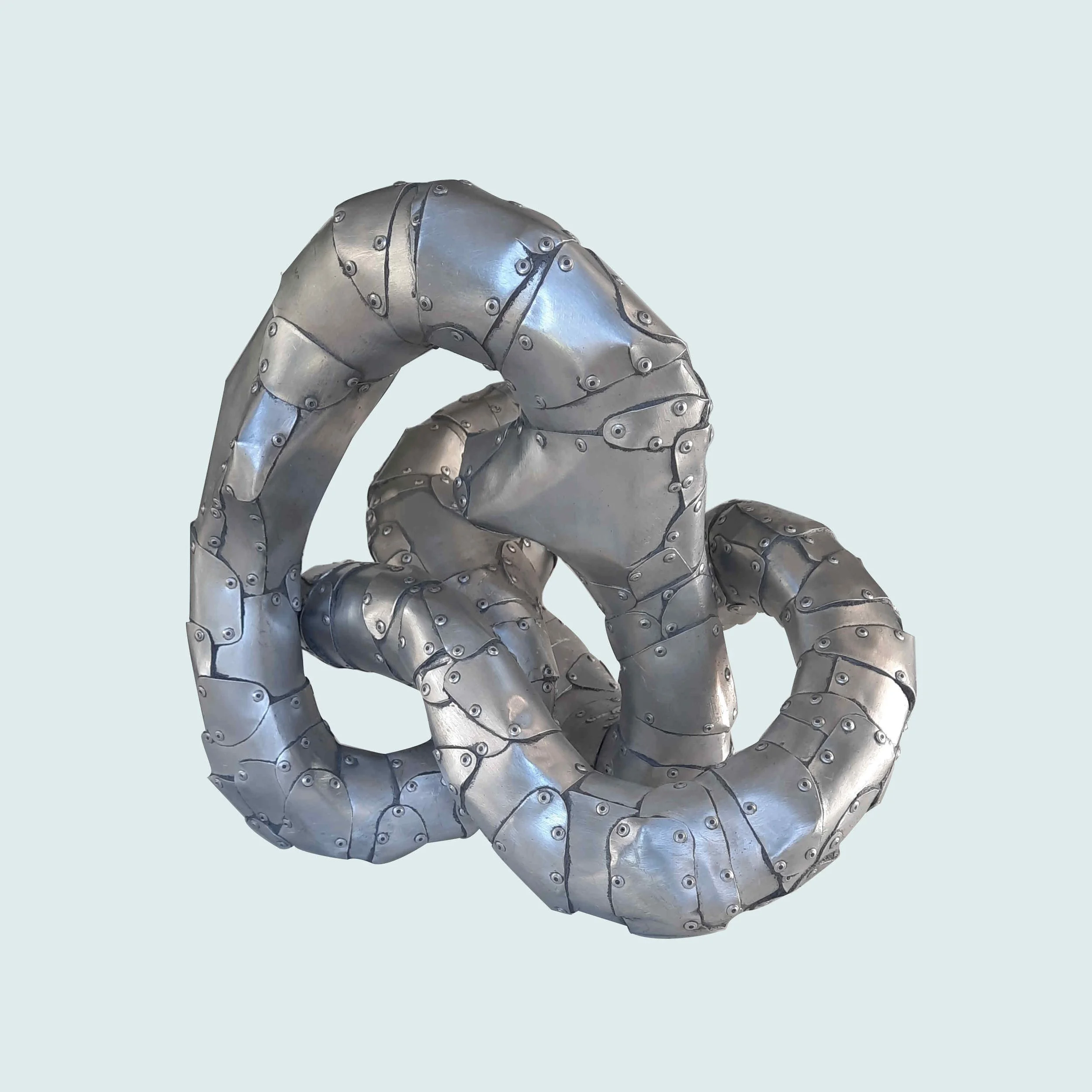 An aspect of a sculpture made of riveted aluminium by Stephen Bond entitled Five Lumps Loop