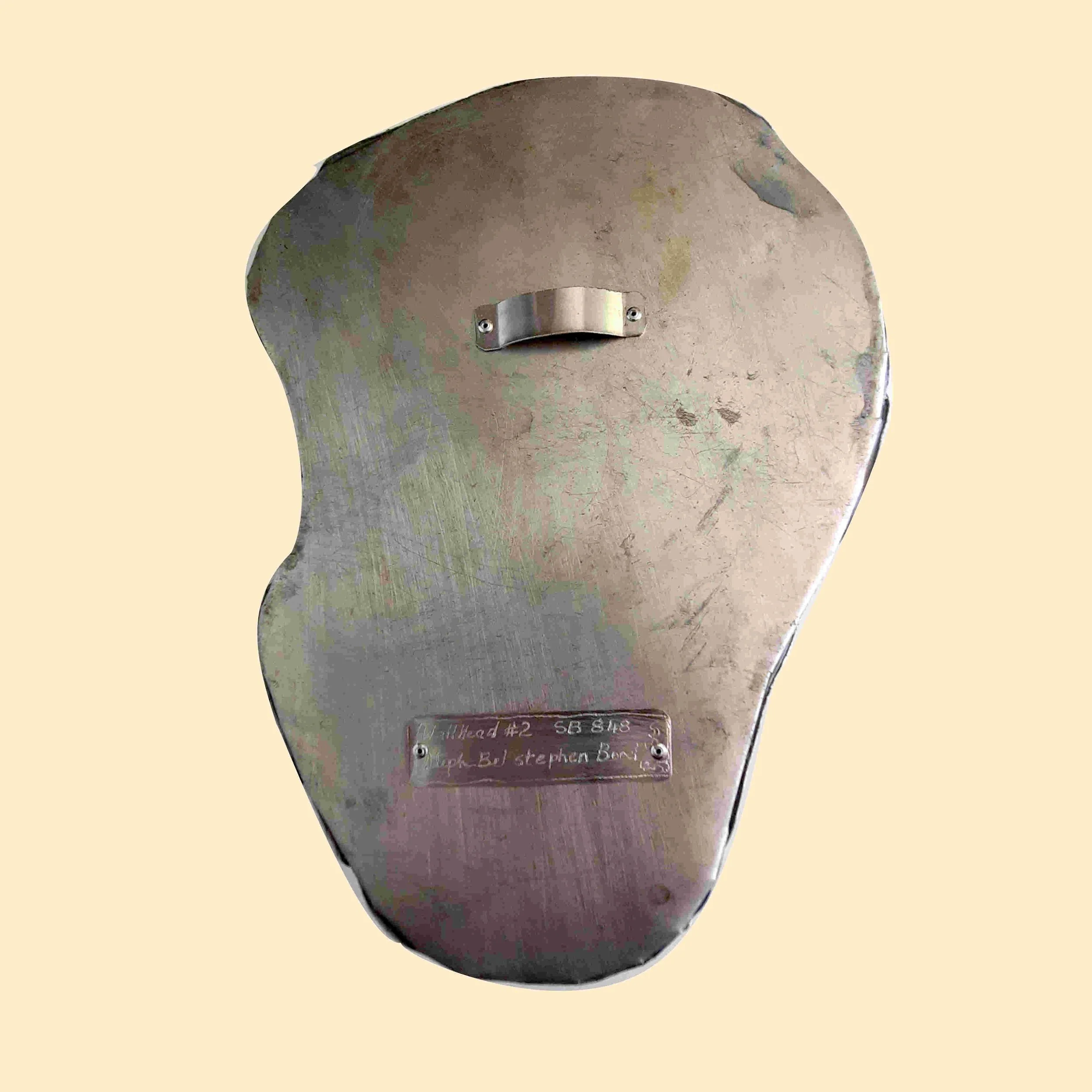 This is an image of the back of Wall Head #2 a relief sculpture by Stephen Bond