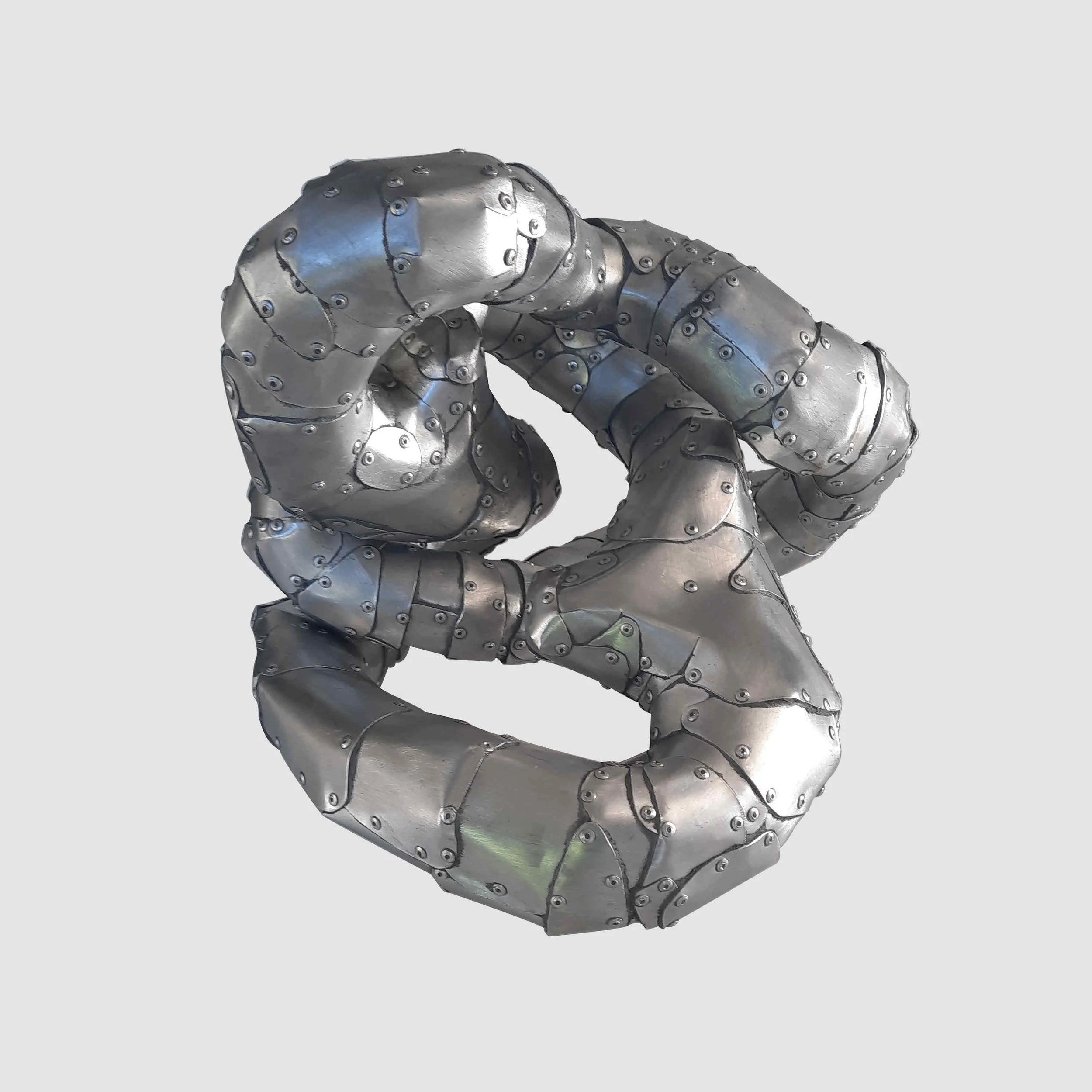 An aspect of a sculpture made of riveted aluminium by Stephen Bond entitled Five Lumps Loop