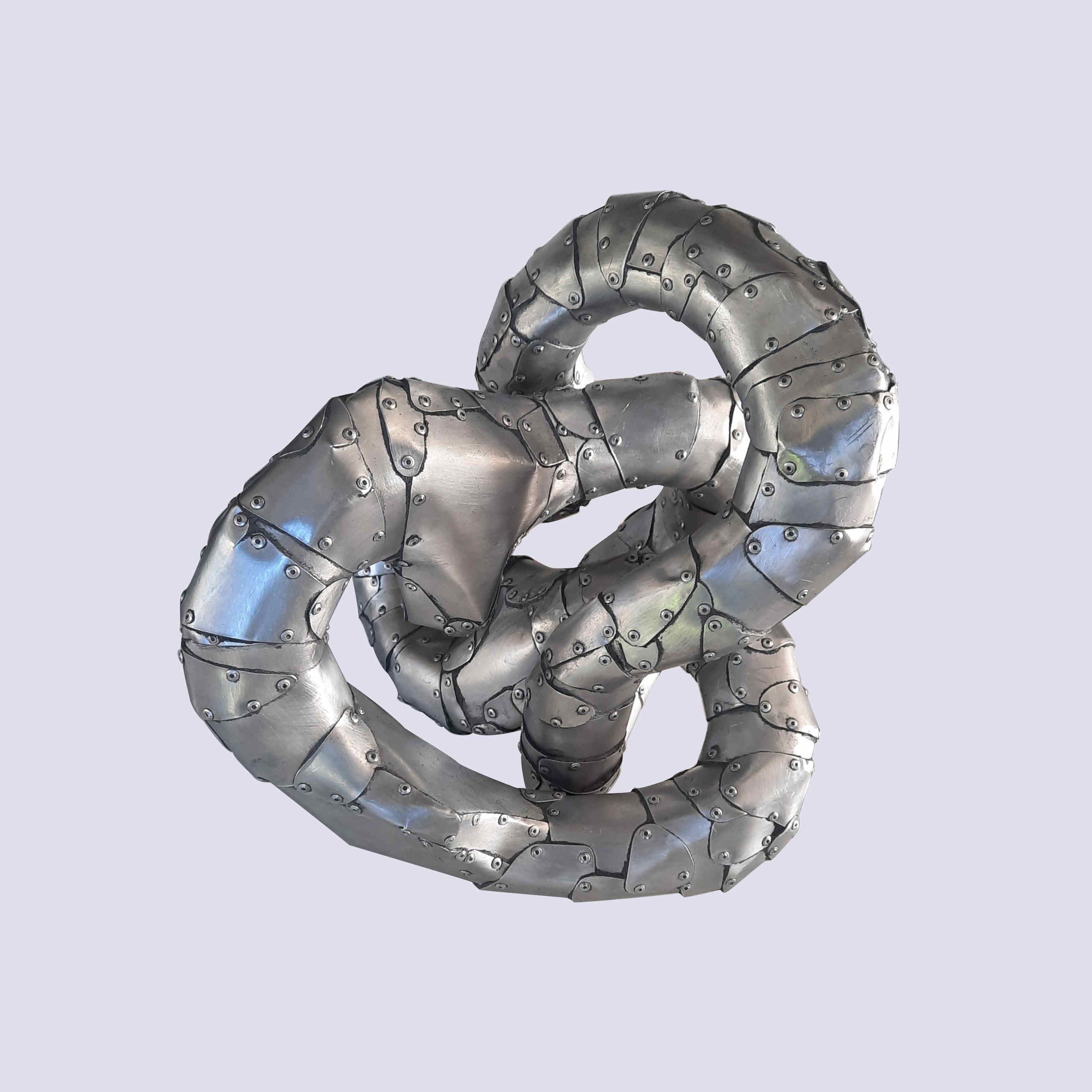 An aspect of a sculpture made of riveted aluminium by Stephen Bond entitled Five Lumps Loop