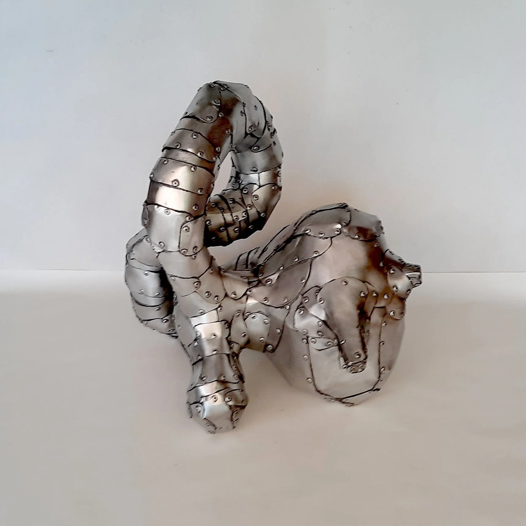 An aspect of a sculpture made of riveted aluminium by Stephen Bond entitled Lump Loop No 4