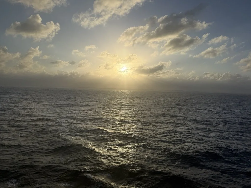 The sun low over open ocean, seen from a ship