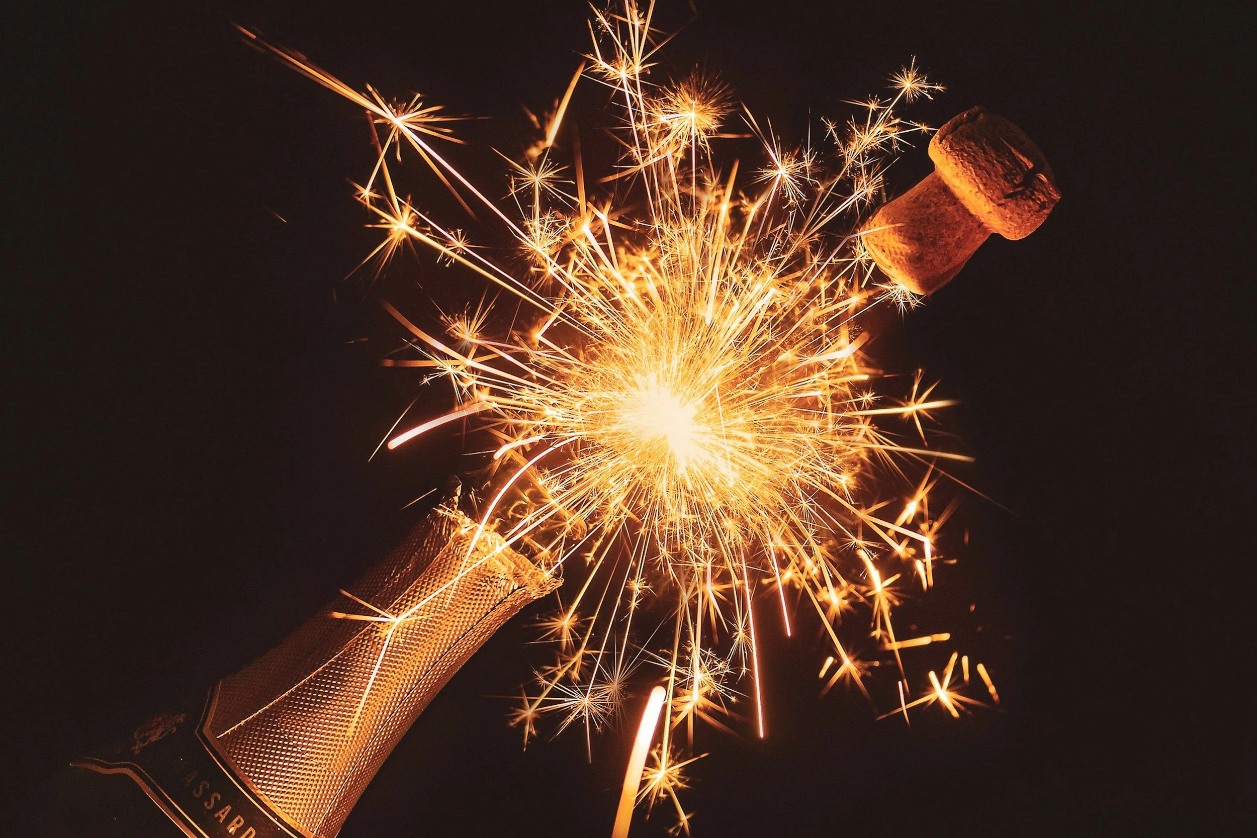 Sparkling champagne bottle popping with a burst of light, symbolizing celebration, growth, and new beginnings in eating disorder recovery and support. Orlando, FL