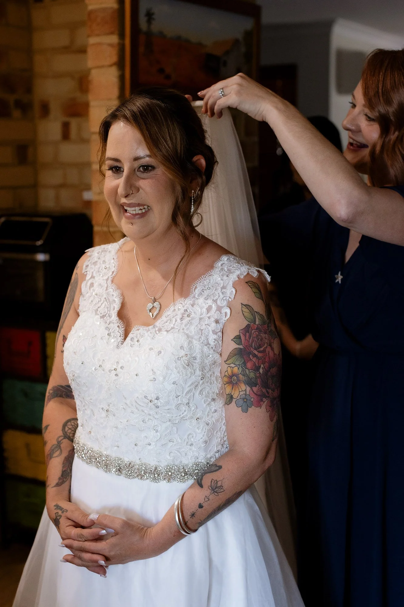 Bride having the veil fitted
