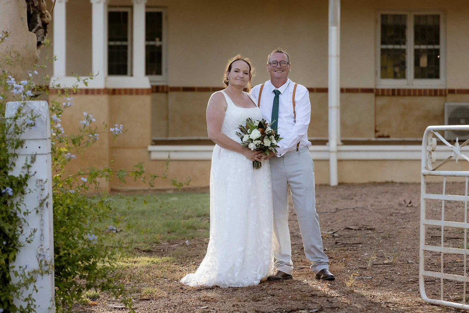 Bride & Groom standing in gateway