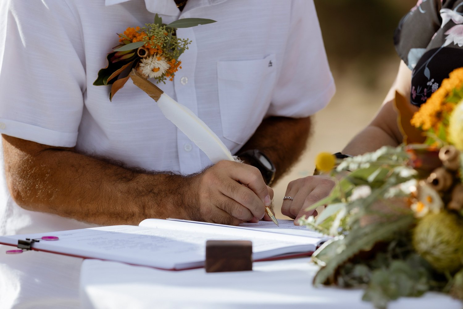 Groom signing Marriage Certificate