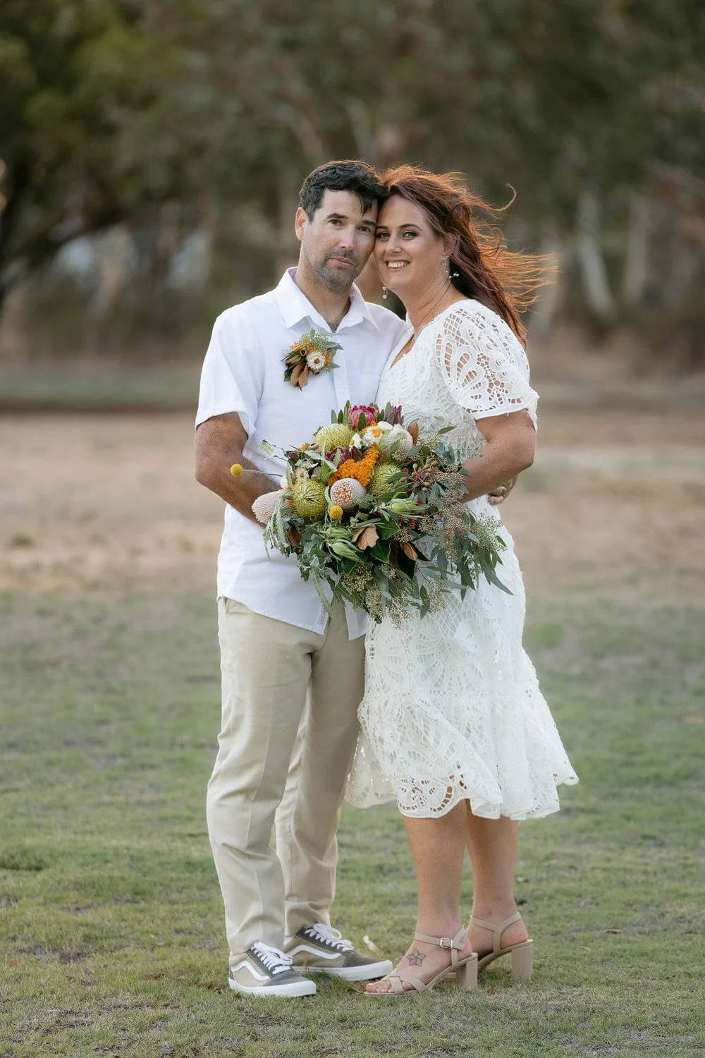 Full length Bride and Groom looking at camera