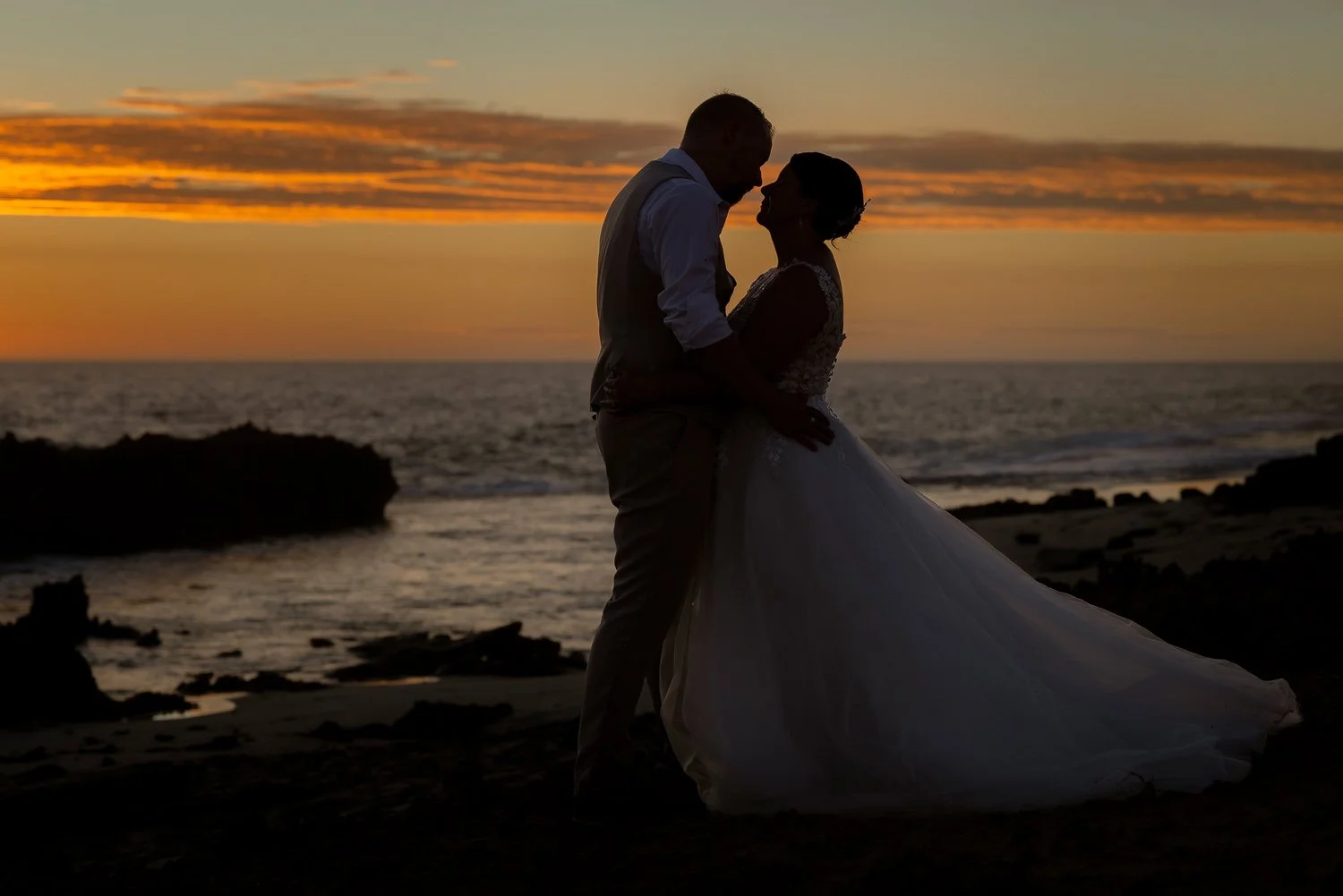 Bride & Groom embrace silhouette at Beach 