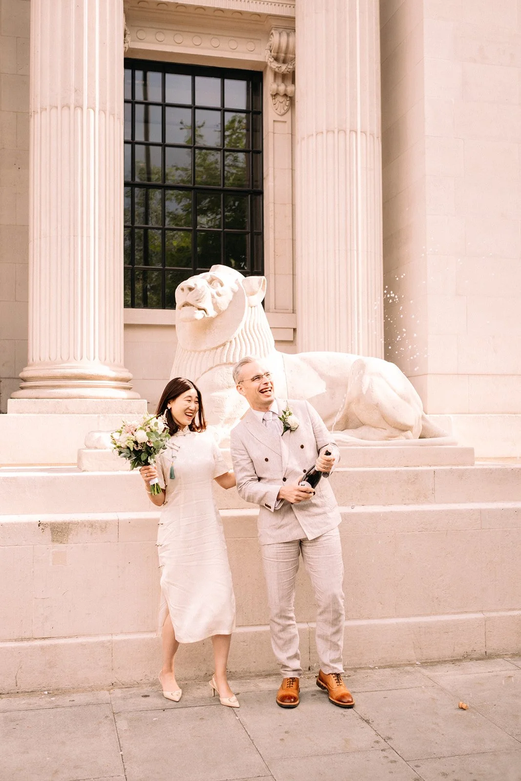 Wedding couple spraying Champagne at Old Marylebone Town Hall