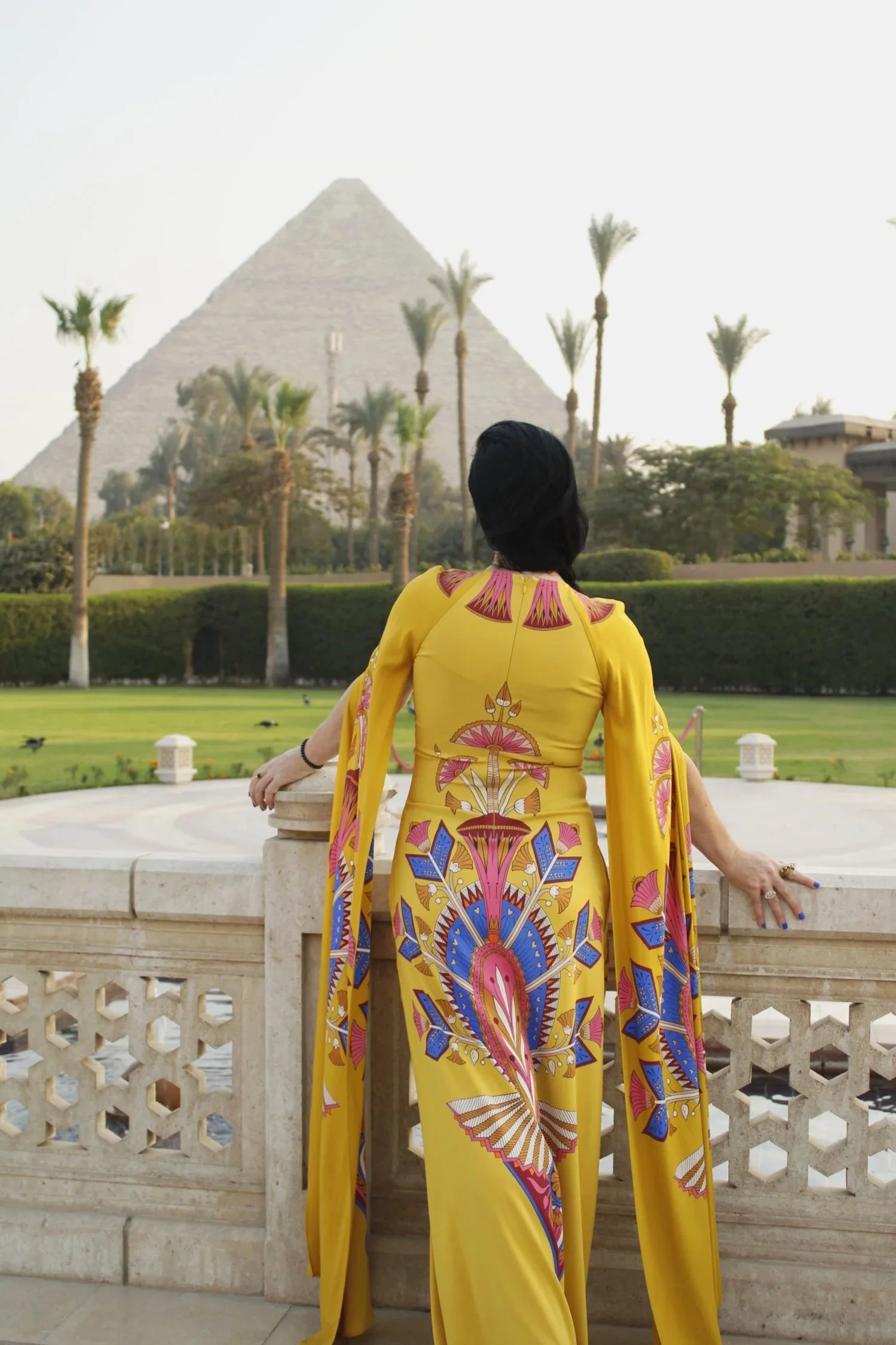 Dee Kennedy in front of the Giza pyramids wearing La Double J dress
