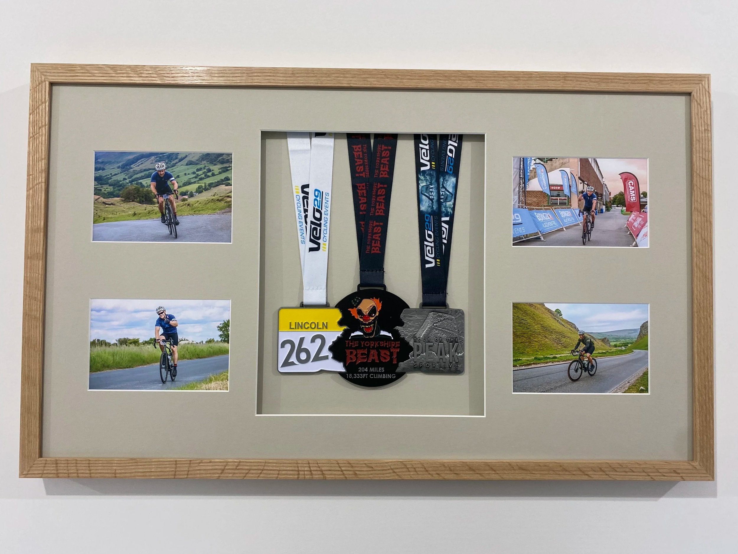 Cycling medals framed with photographs