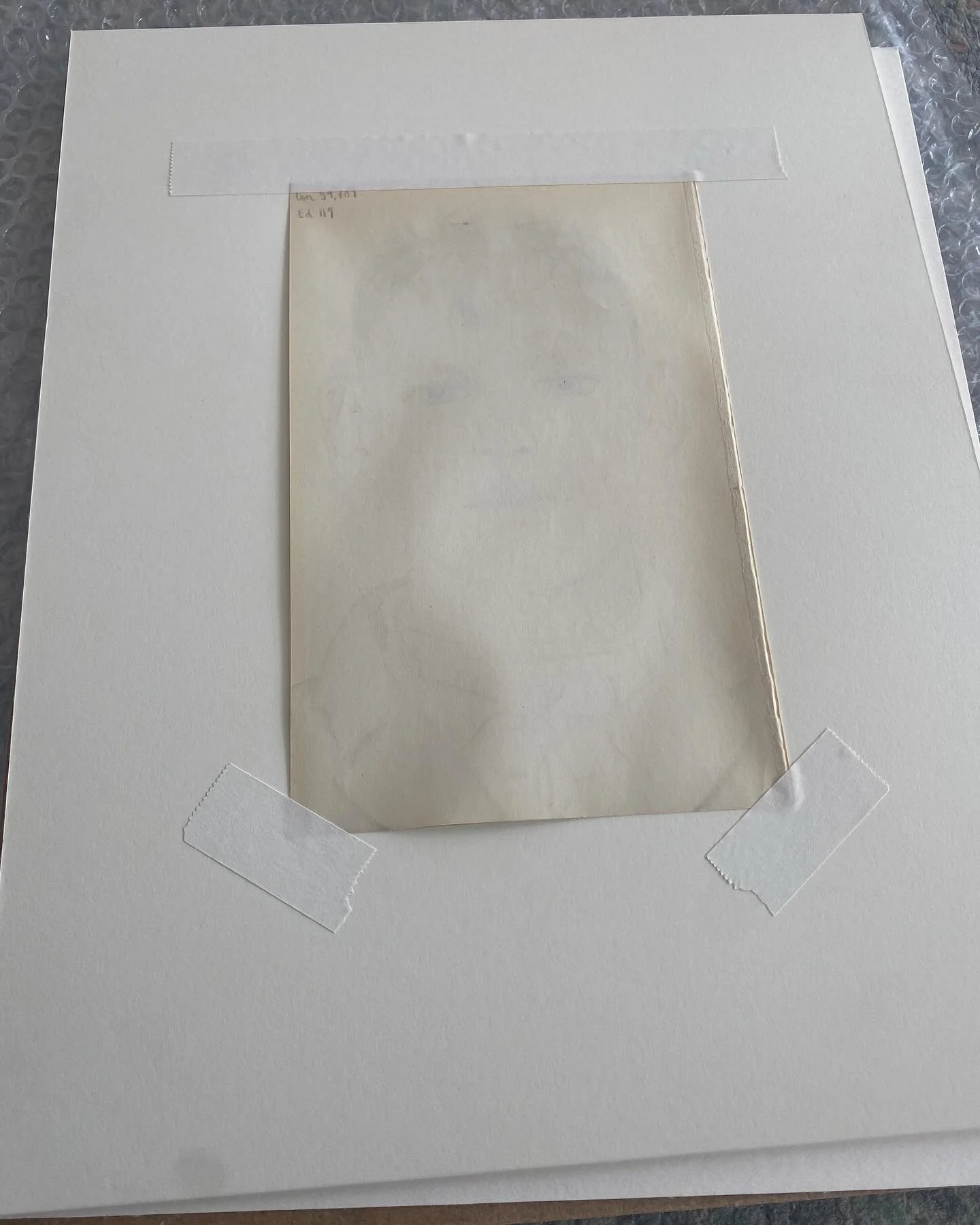 🚫 A classic, and all too frequent example of how NOT to mount artwork..

❌ Taped to the window mount

❌ Self adhesive tape

❌ Tape applied to numerous points around the print, denying the print the ability to contract and expand, resulting in buckli