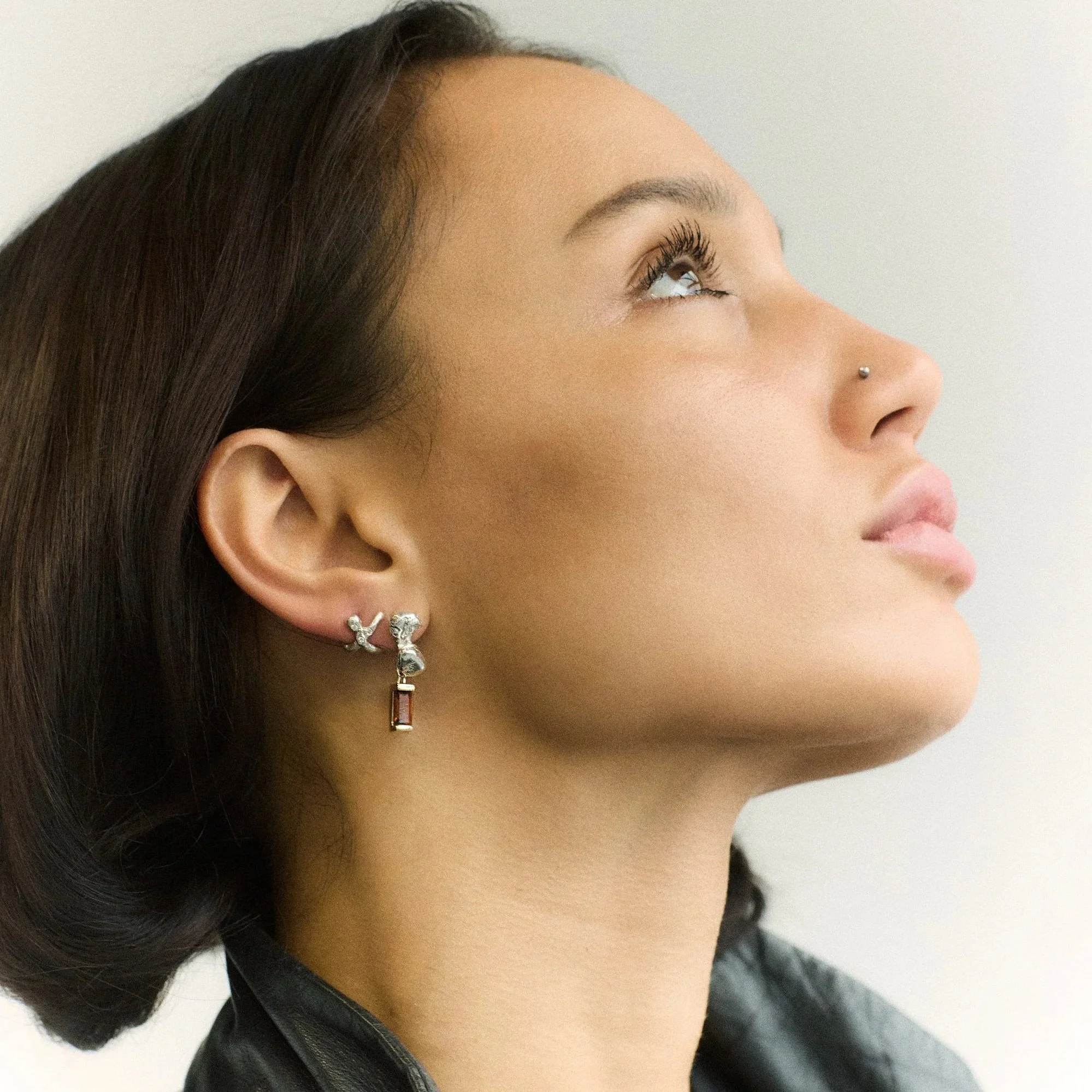 black leather coat and drop earrings