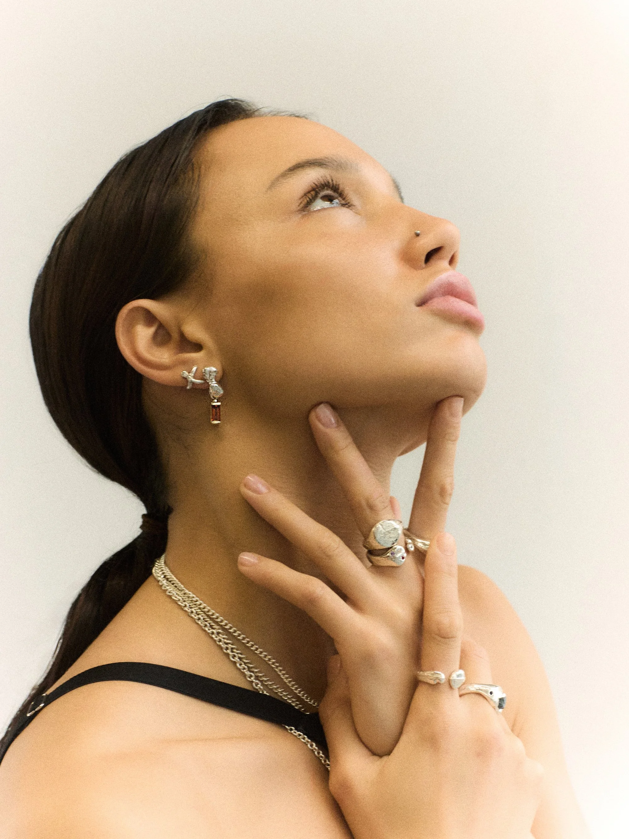 Jewellery clad model in black dress