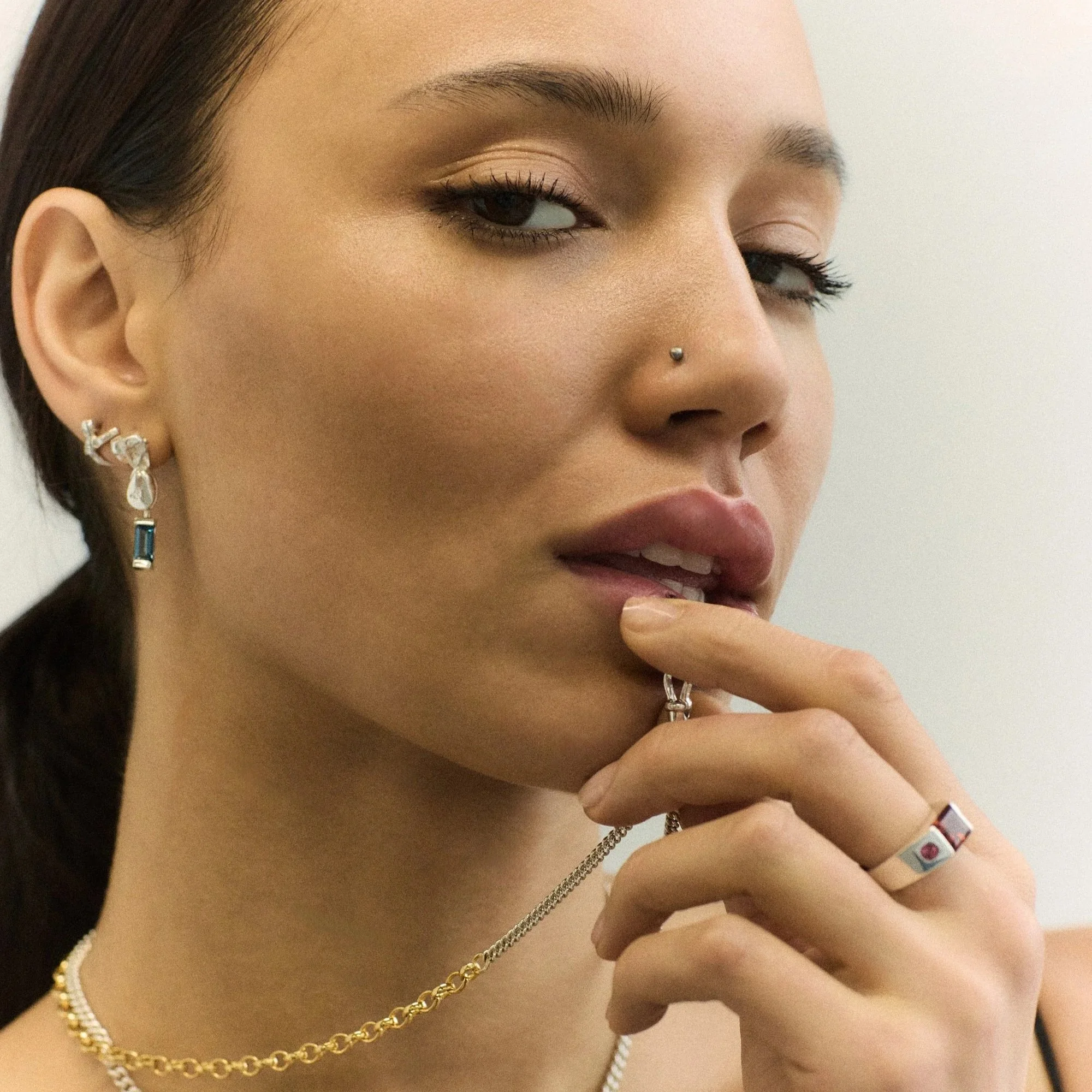 model with necklace in mouth