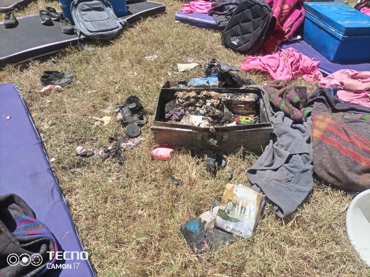 Scorched belongings amidst chaos after fire