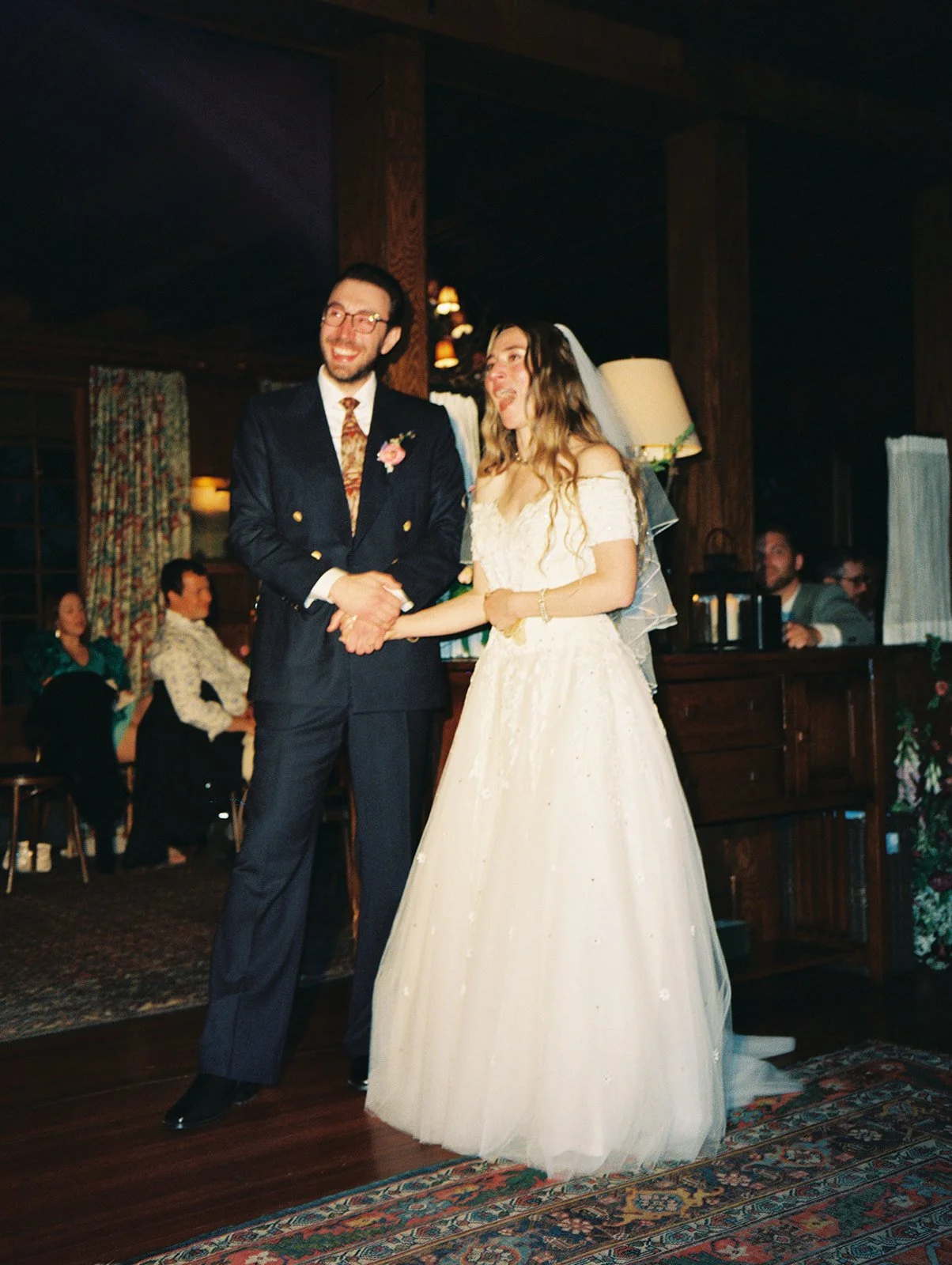 Bride and groom listening to speeches during their Deer Mountain Inn wedding reception.