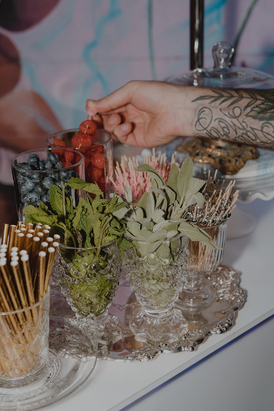 Sorbet and Rose garnish station with fresh herbs, berries, and glassware at a Velveteen Rabbit Las Vegas micro wedding reception.
