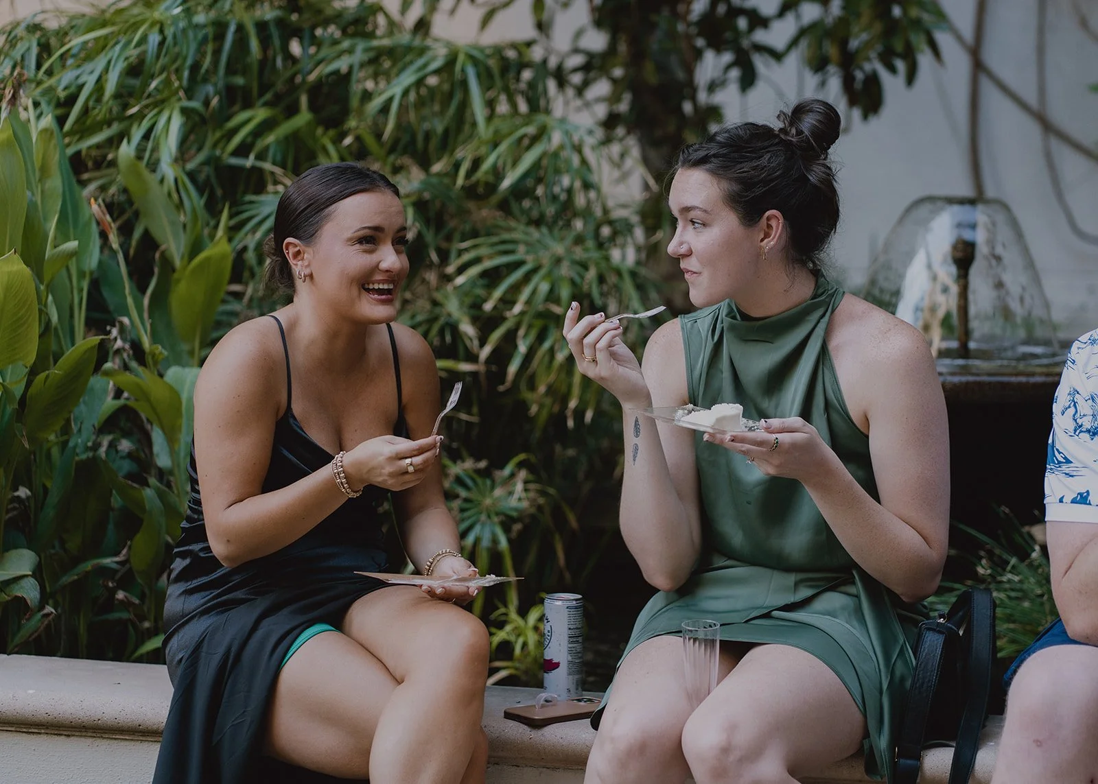 Guests laughing and enjoying drinks and cake.