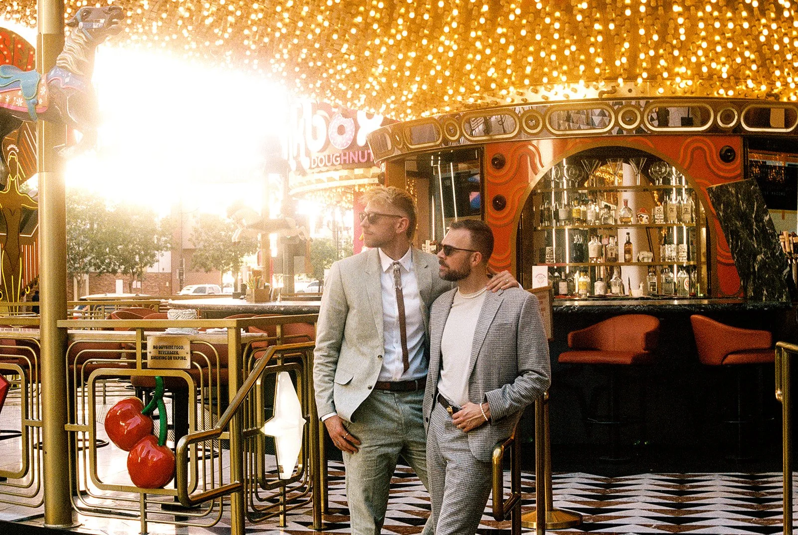 Couple posing on the steps of Carousel Bar in Las Vegas for their Fremont Street elopement photos.