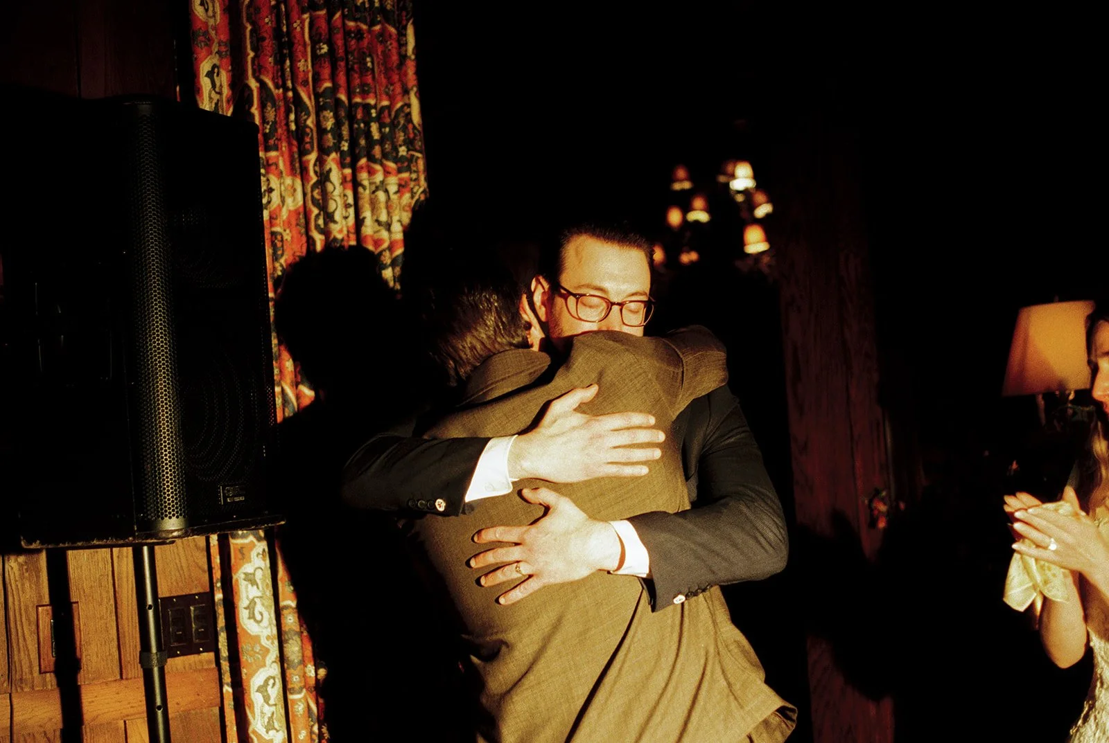 Groom hugging a guest after speeches.