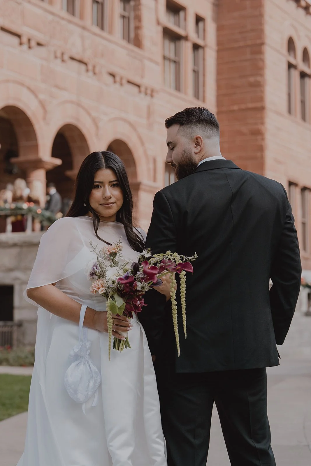 Couple posing outside of the Old Orange County Courthouse in Santa Ana, California.