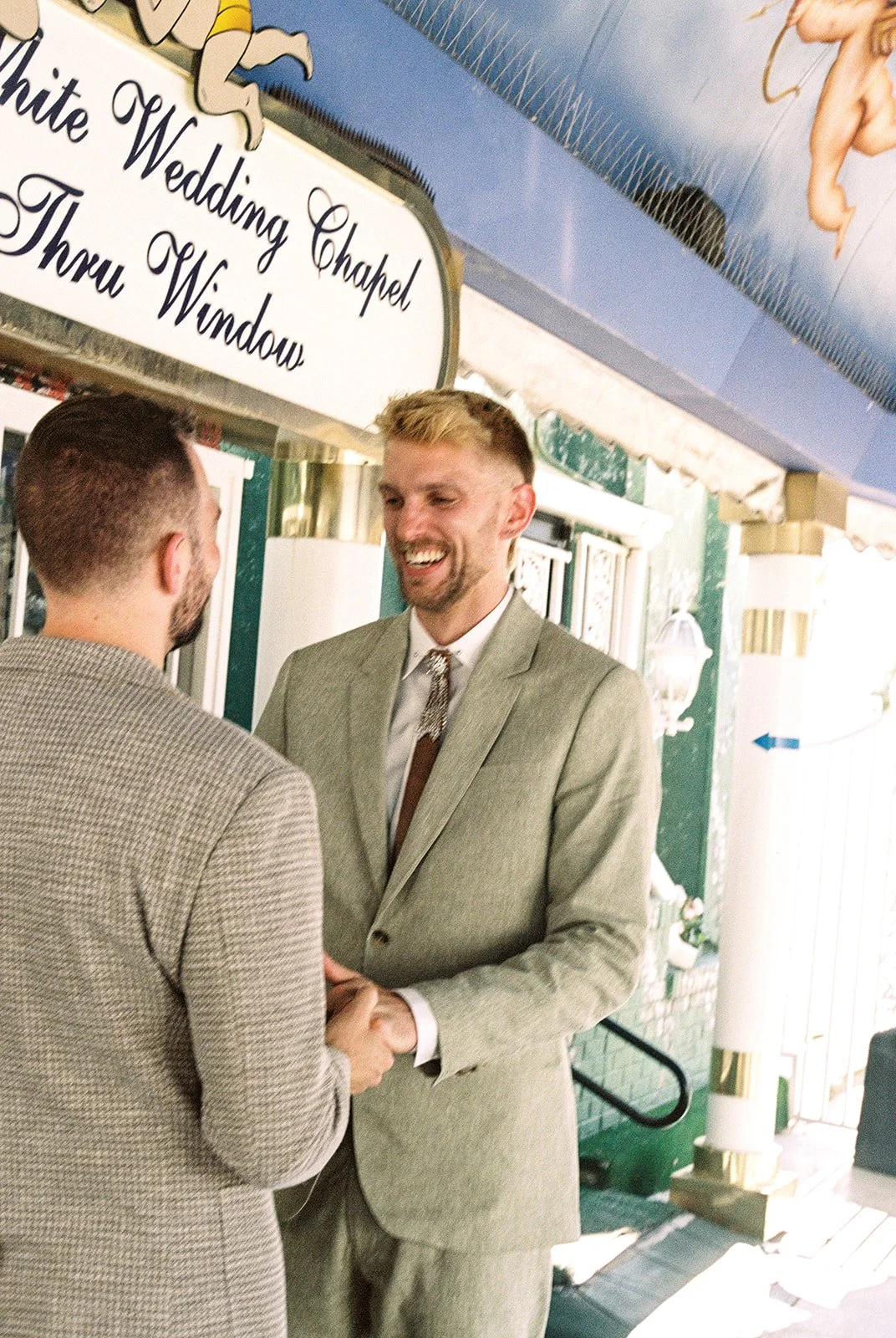 Groom smiling during his emotional Little White Chapel elopement in Las Vegas on 35mm film.