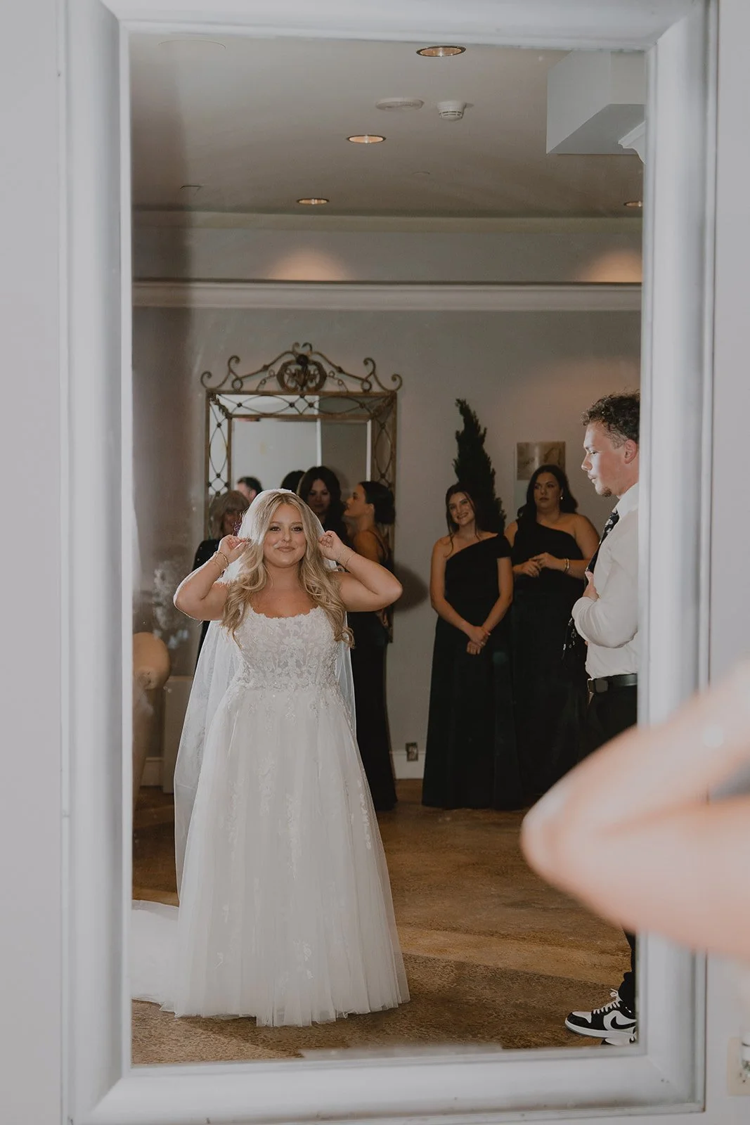 Bride adjusting her veil while surrounded by loved ones before her Caesars Palace micro wedding in Las Vegas.