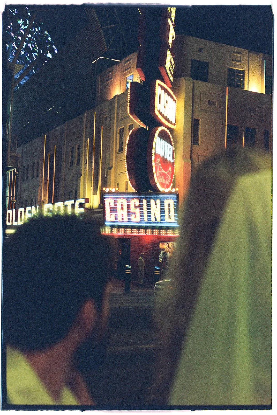 Bride and groom looking at the Golden Gate Hotel and Casino sign on 35mm film.