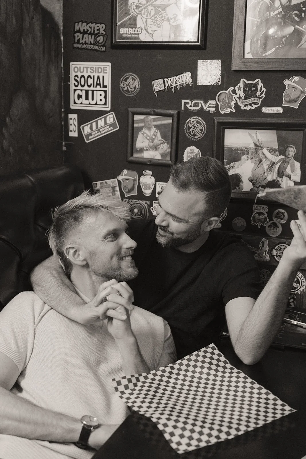Black and white photo of a couple eating pizza at Evel Pie after their elopement.