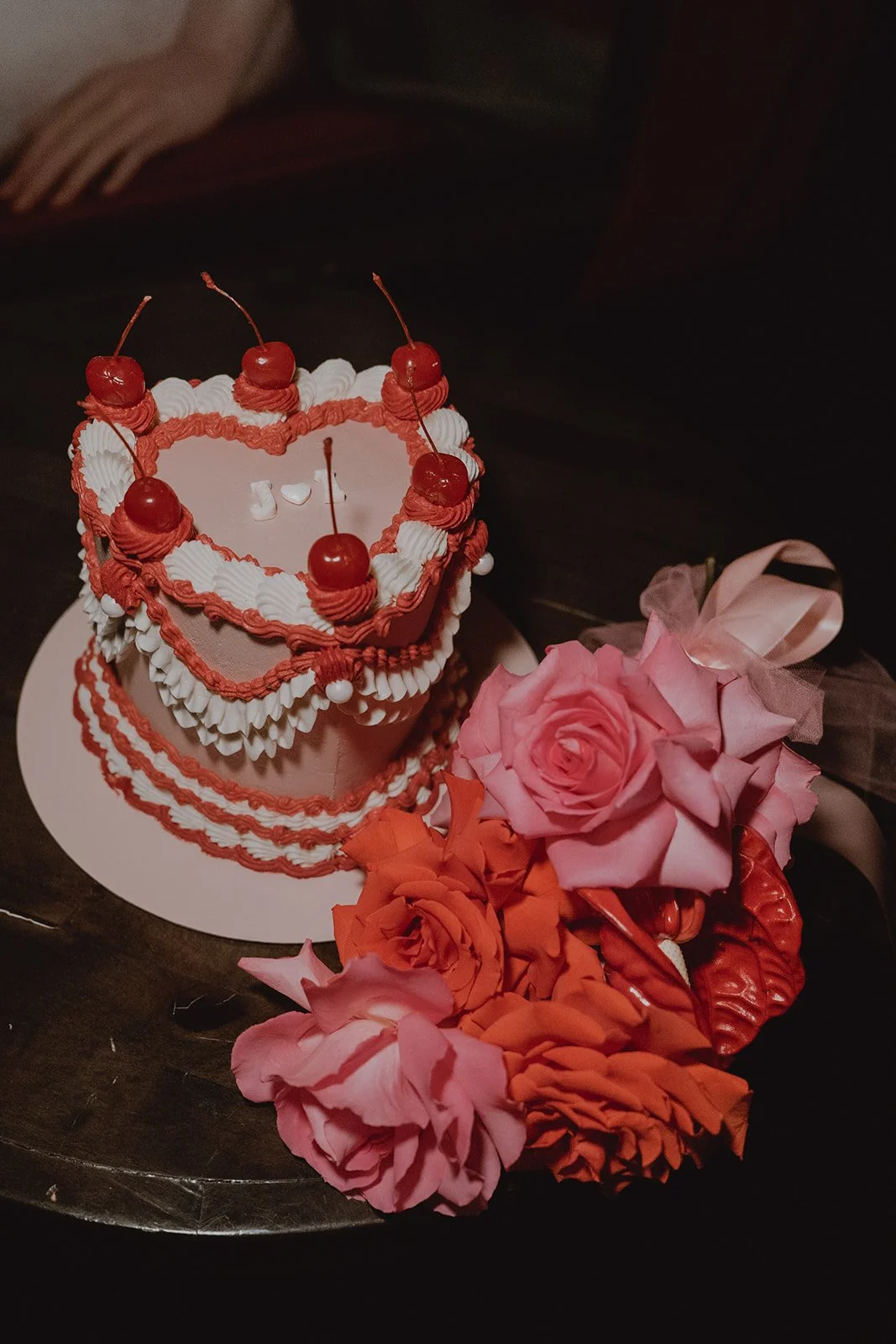 Heart-shaped wedding cake with cherries and floral details at Cheapshot Las Vegas reception.