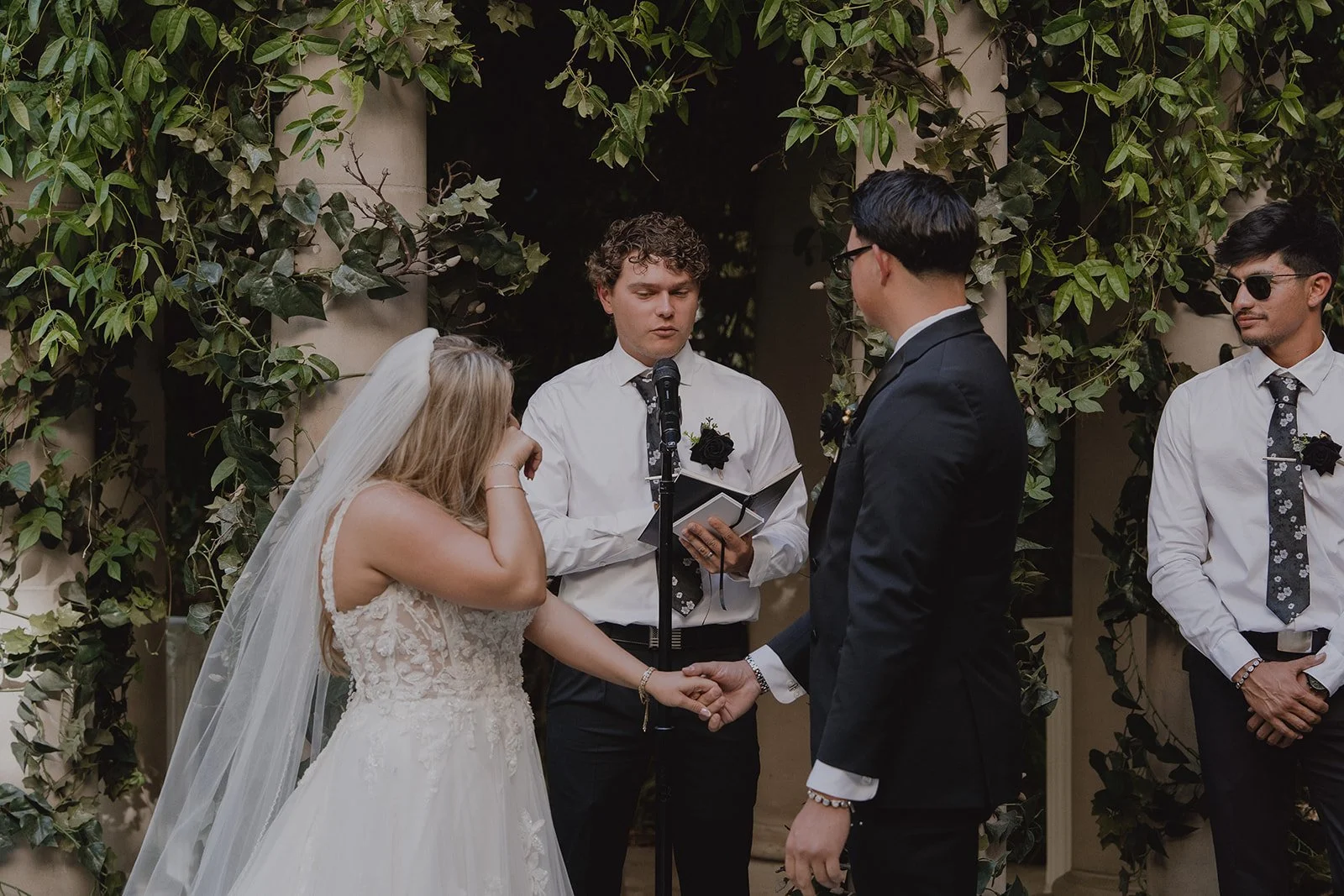 Bride getting emotional as the officiant speaks during her ceremony